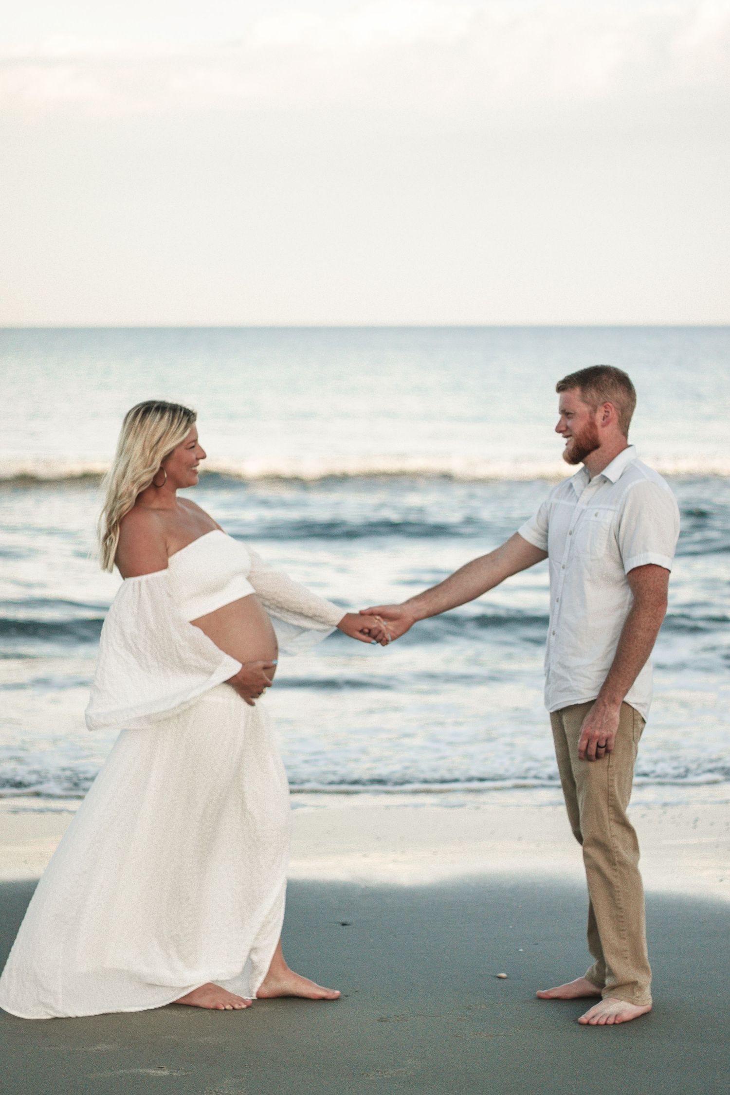 Dancing and twirling sequence of couple on beach in white dress and khaki pants.