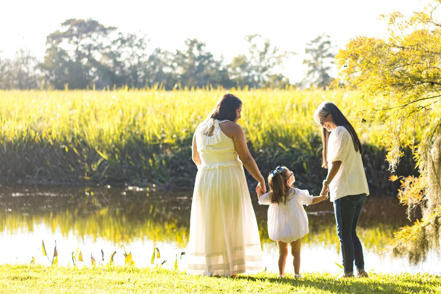 A series of romantic sunset photos showing silhouettes of people by a lake in golden sunlight.