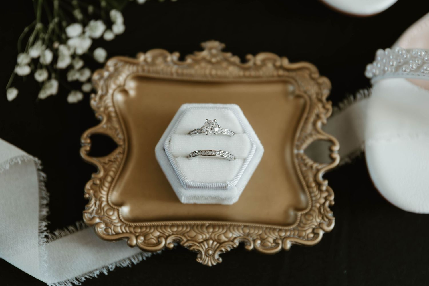 Ornate gold-framed decorative mirrors with intricate baroque details displayed against a white wall.