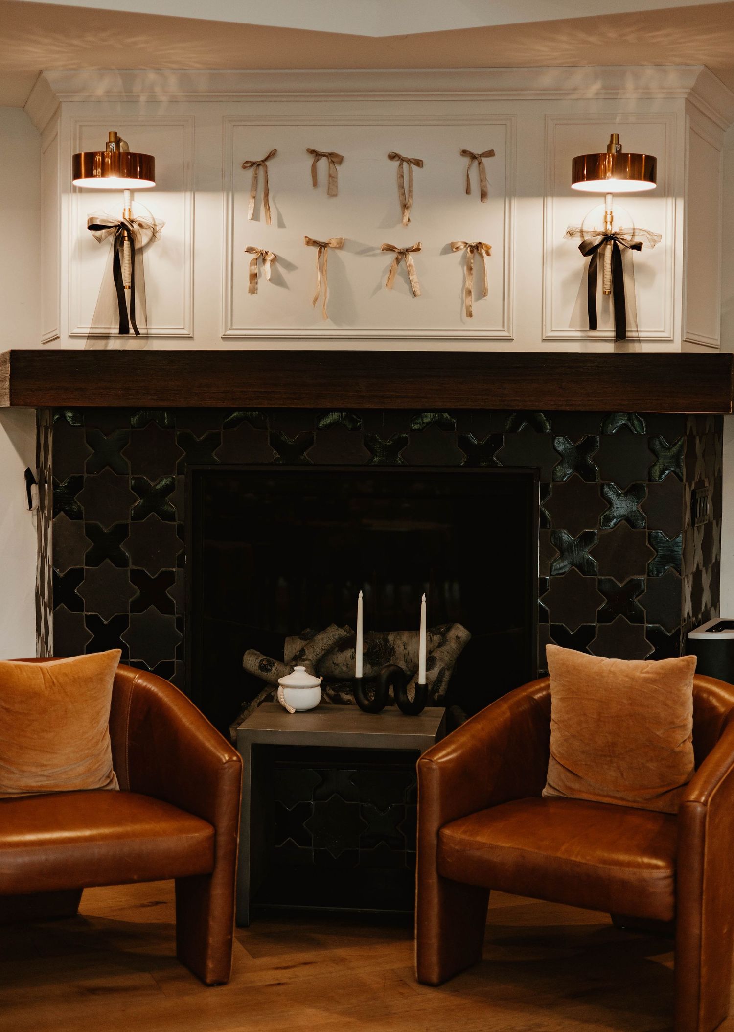 Modern venue interior with brown leather seating and decorative lighting fixtures.