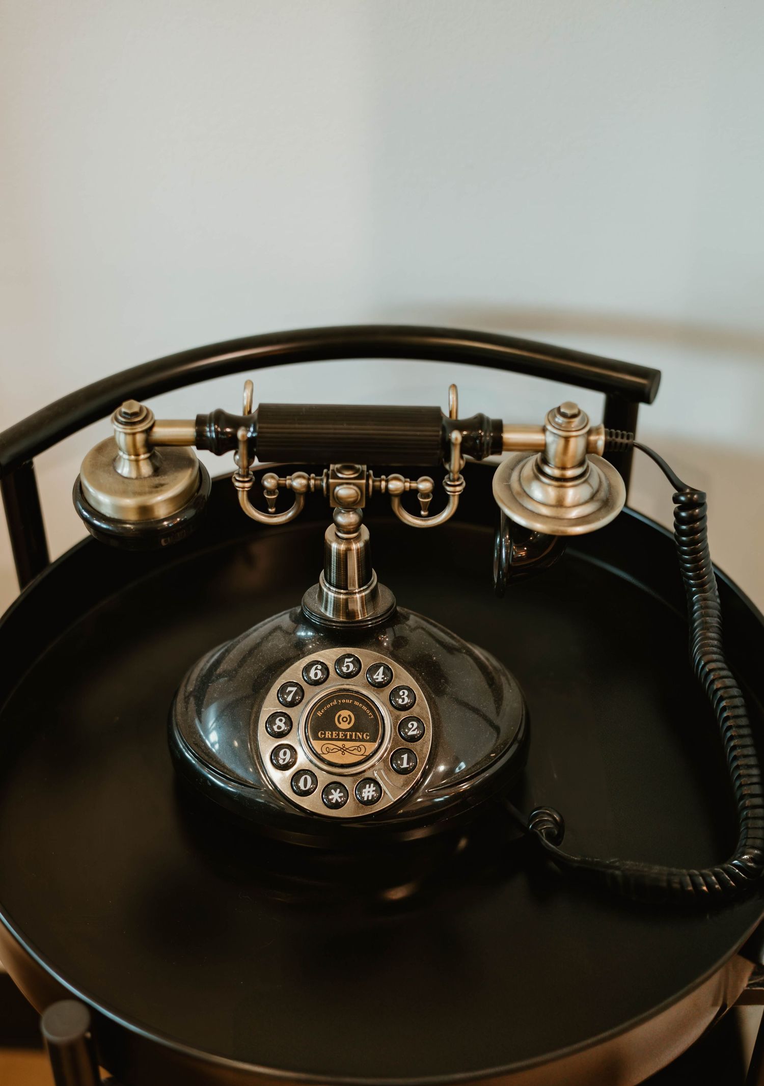 Vintage rotary telephone dial shown in artistic black and white composition.