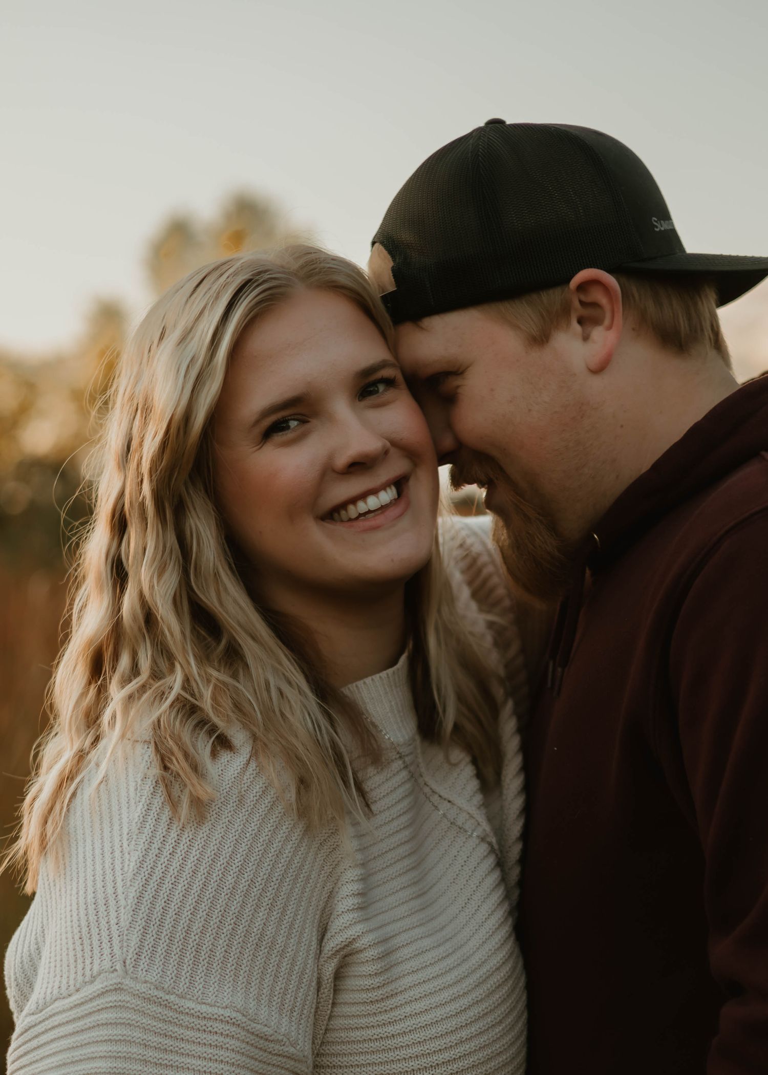 Couple sharing intimate moments in a series of warm sunset photos showing affection and laughter.