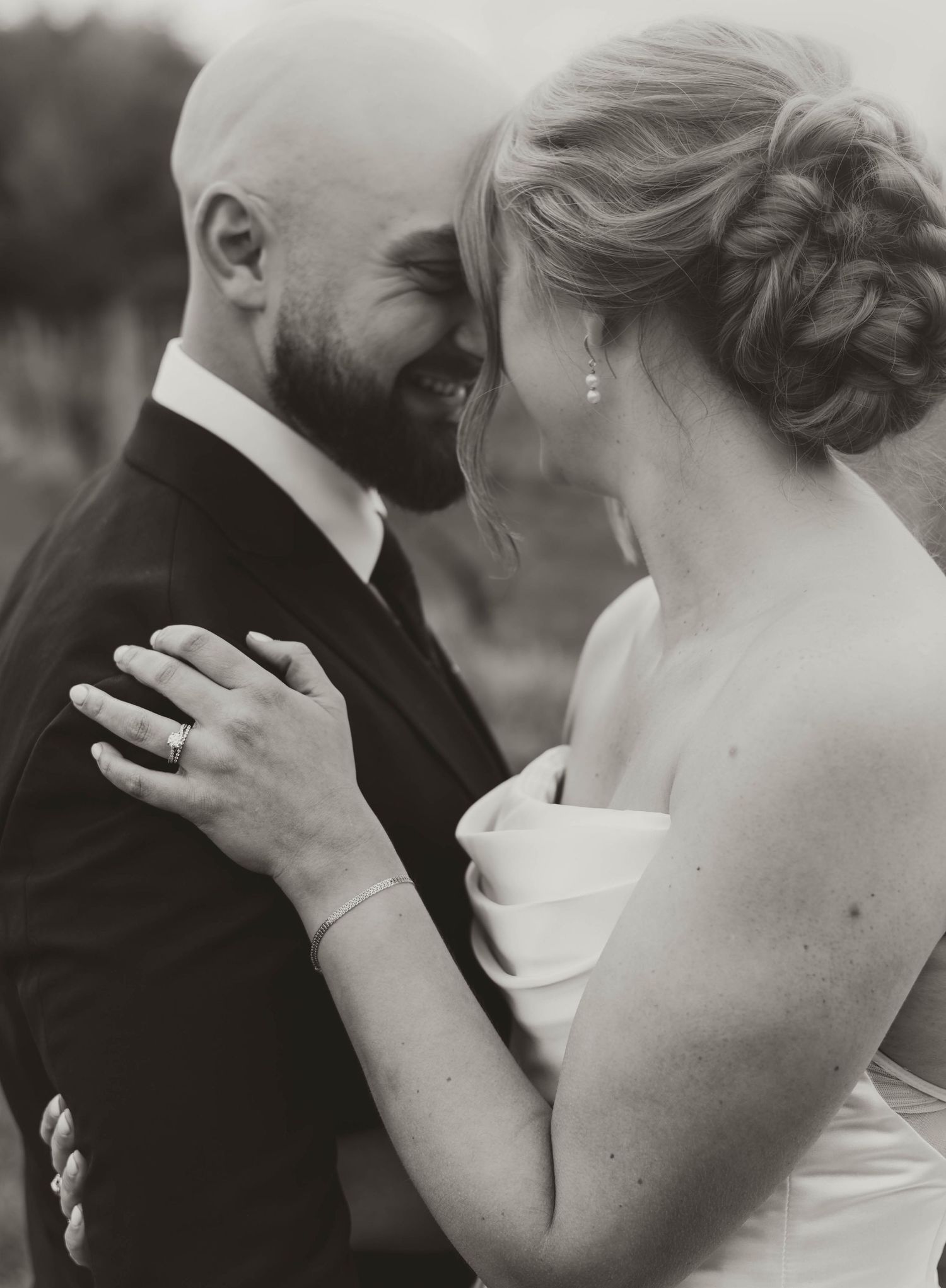 A series of intimate black and white wedding photos showing tender moments between newlyweds.