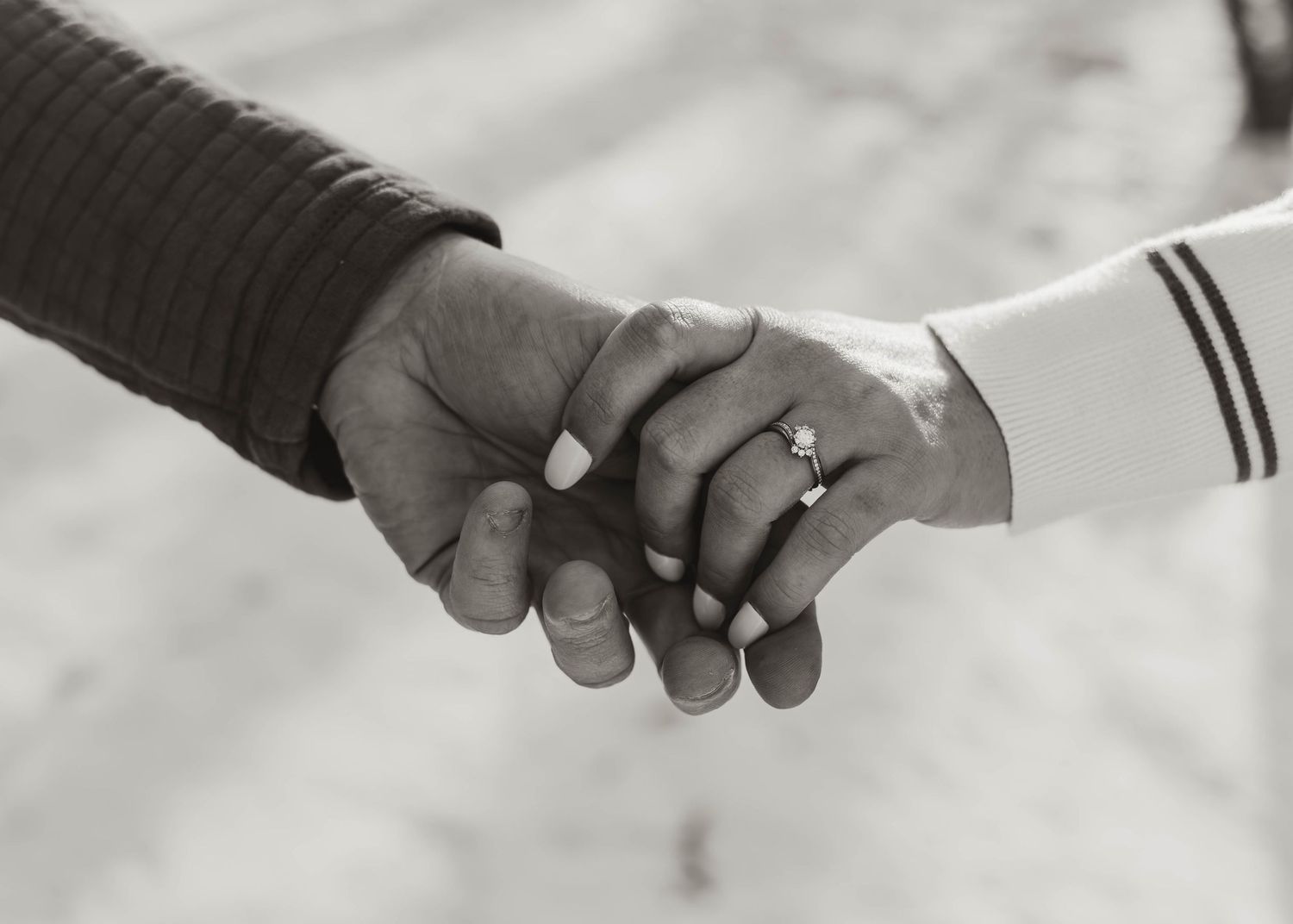 A close-up sequence of hands exchanging wedding rings during a marriage ceremony.