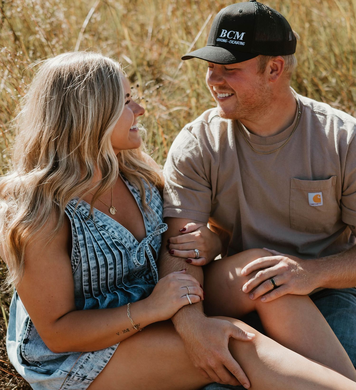 Series of intimate maternity photos showing couple embracing in a golden wheat field at sunset.