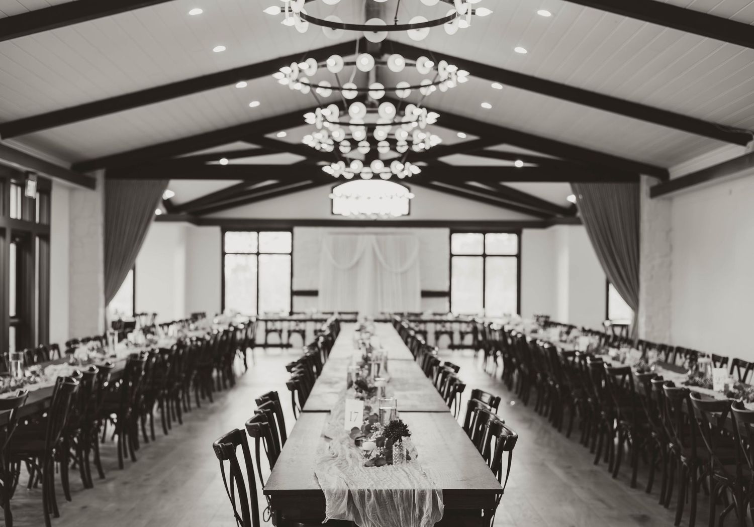 Black and white panoramic photos show an elegant banquet hall with chandeliers and rows of tables set for a formal event.