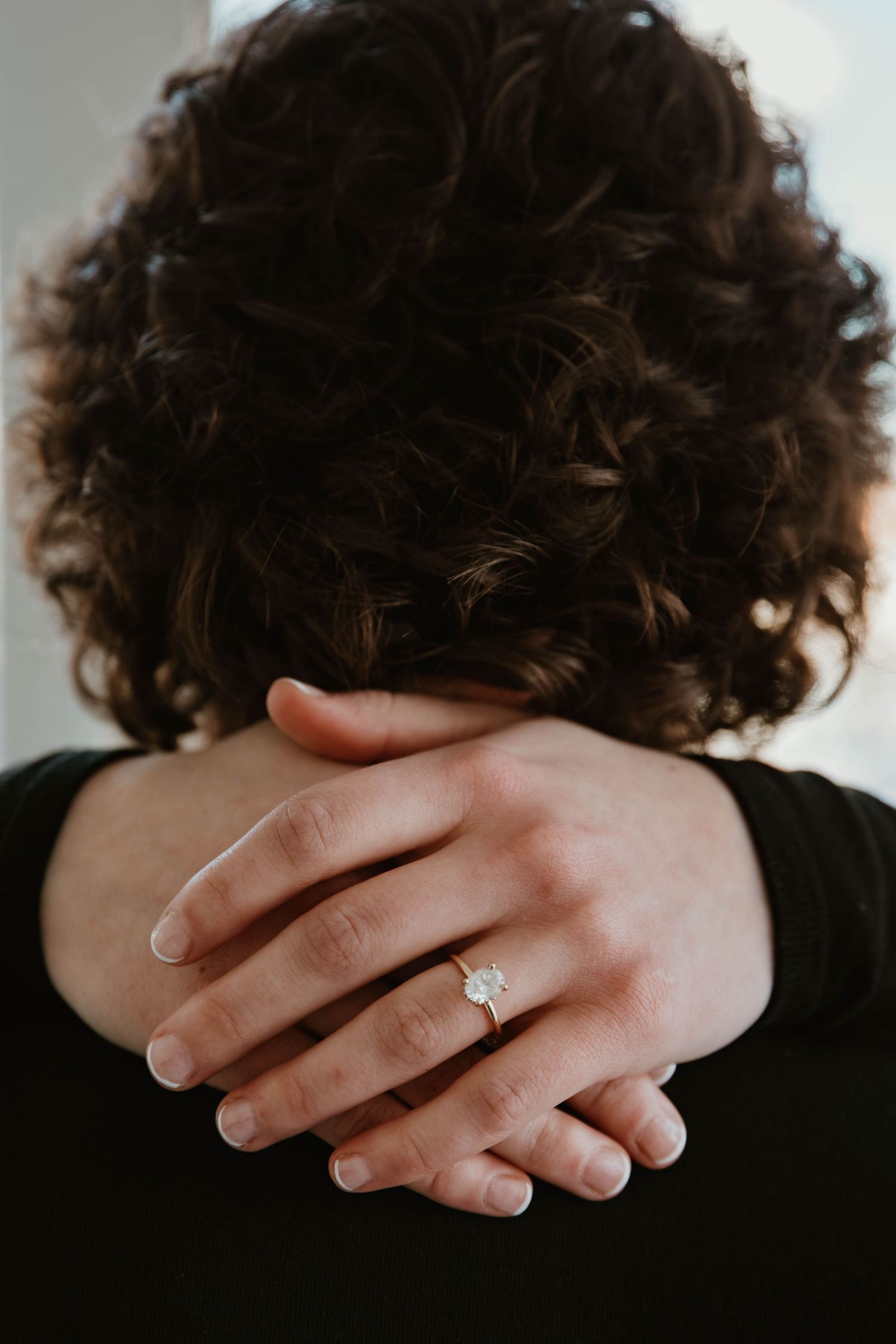A close-up series showing hands with an engagement ring from different angles against a dark background.