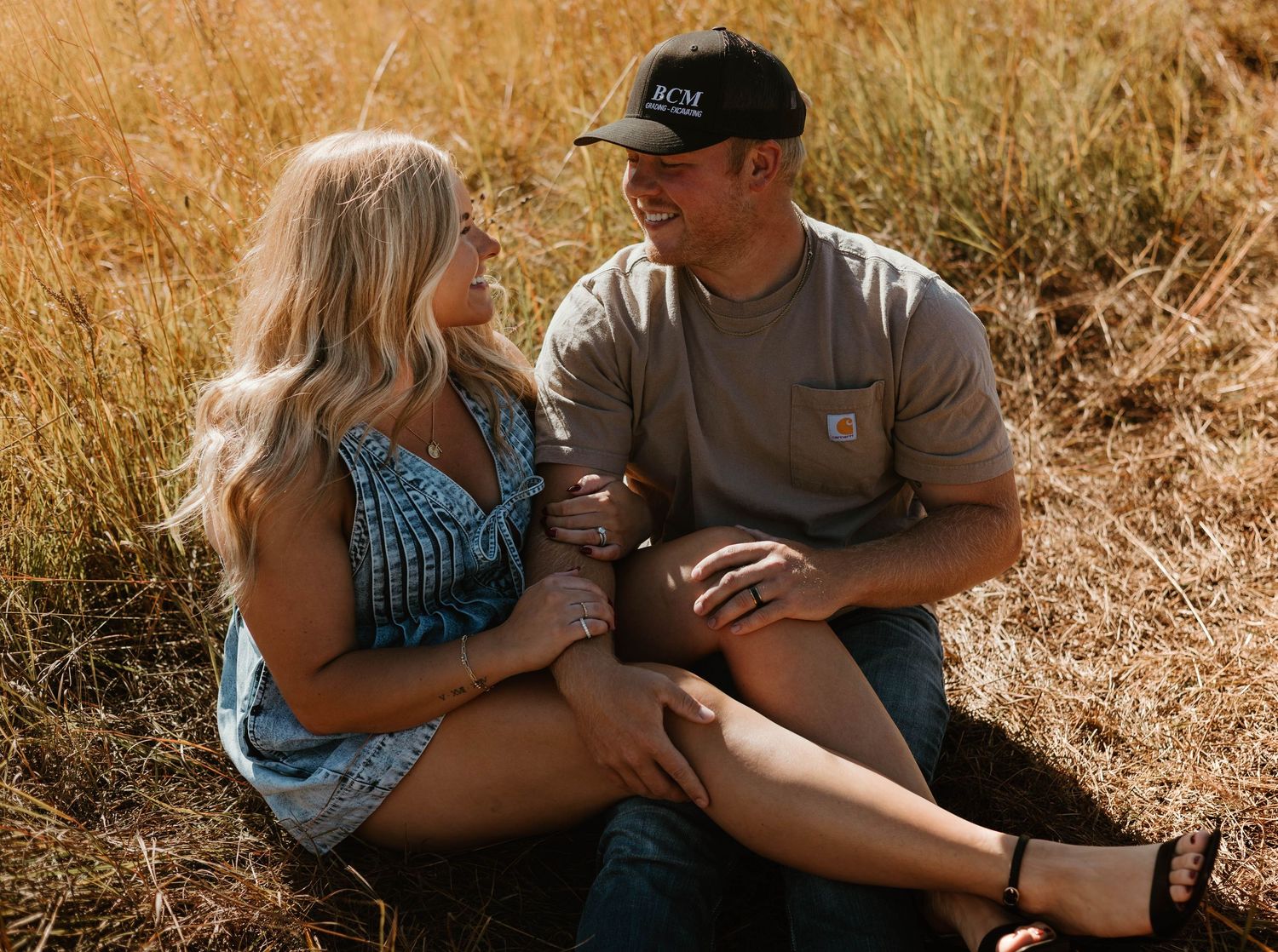 Close up shots of a couple sitting together in a rustic outdoor setting with warm autumn lighting.