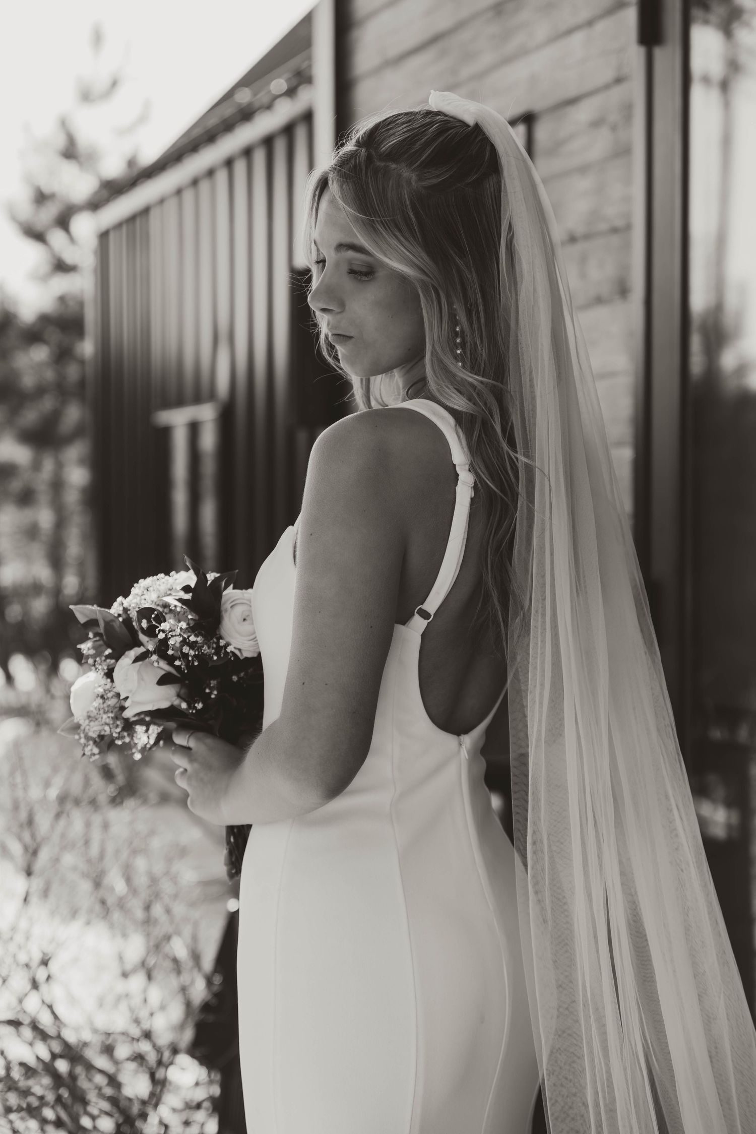 Black and white wedding portraits featuring elegant bridal gown and flowing veil.