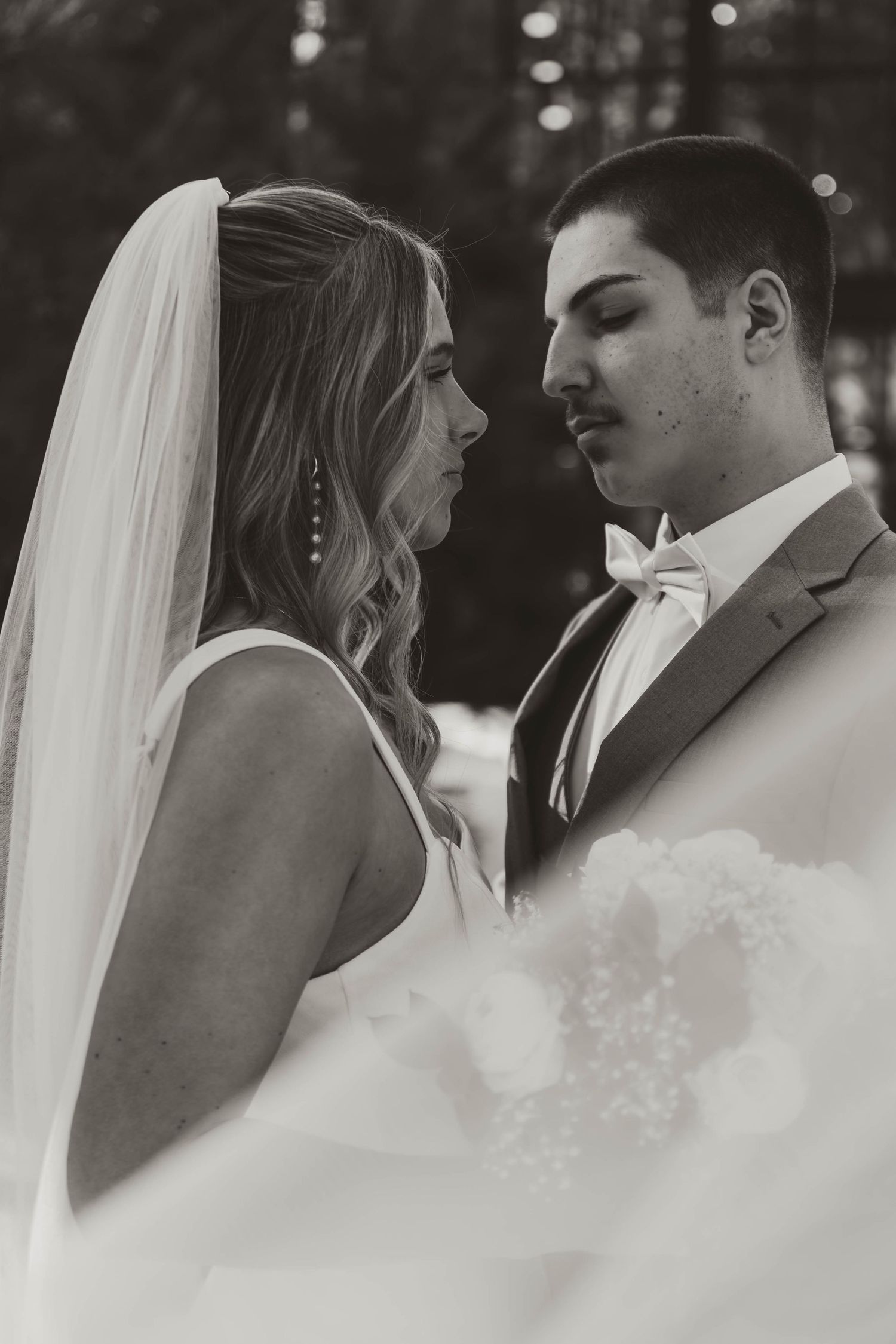 An intimate black and white close-up wedding portrait.