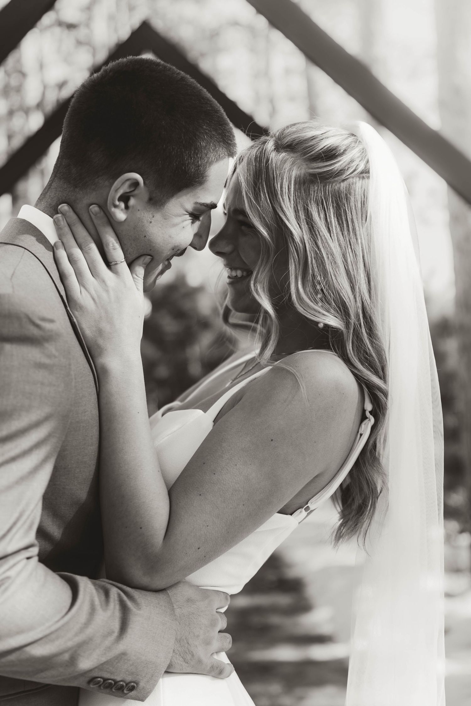 Black and white wedding photos capturing tender moments between a couple in soft natural light.