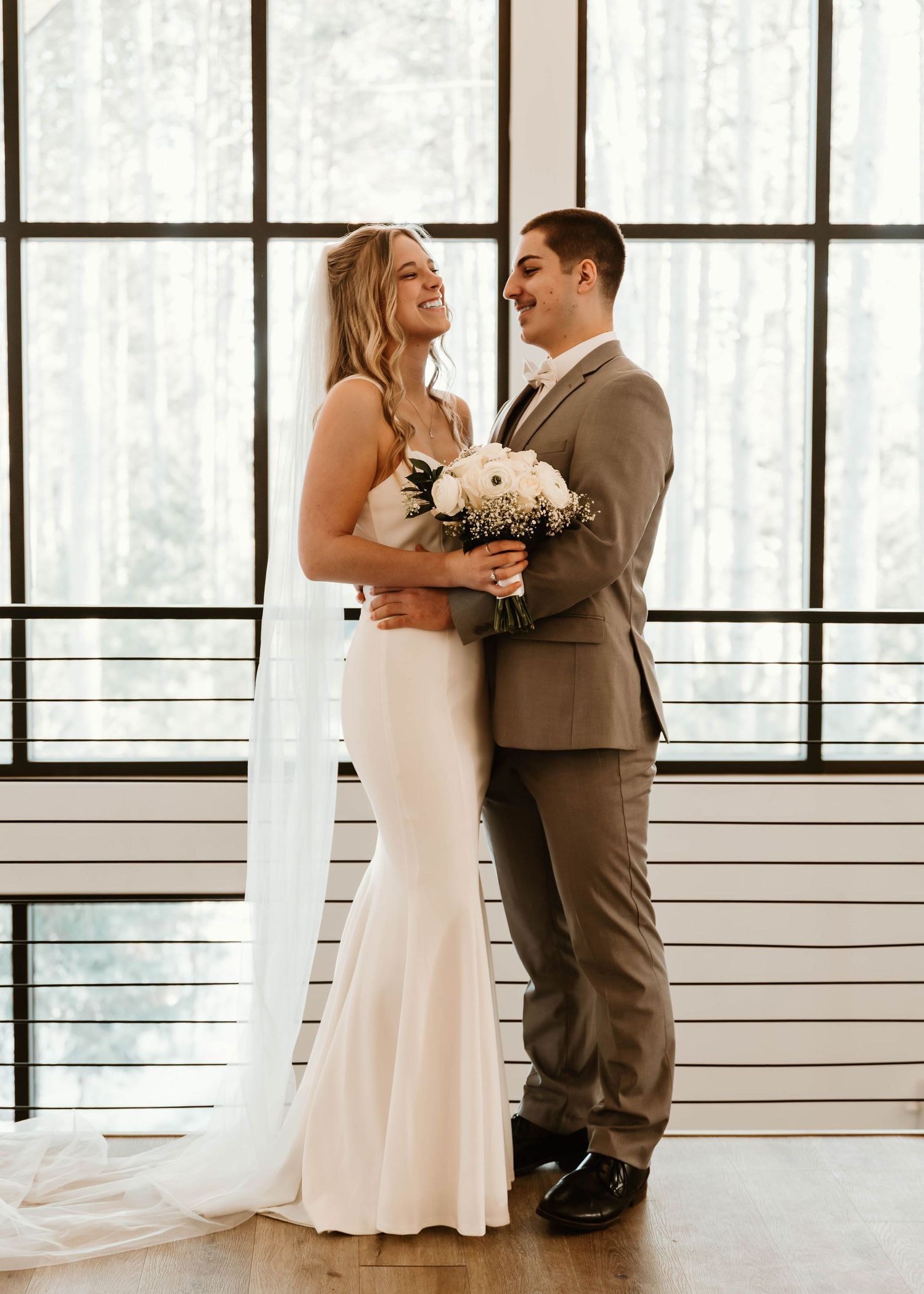 Elegant wedding venue interior with large windows and white walls.
