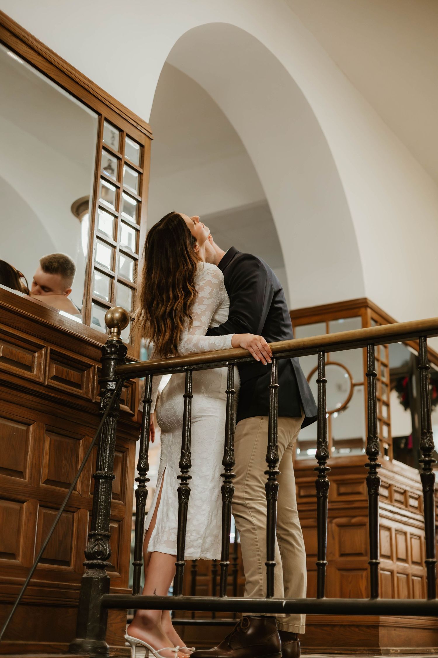 A romantic dance sequence on wooden stairs showcasing elegant wedding attire and intimate moments.