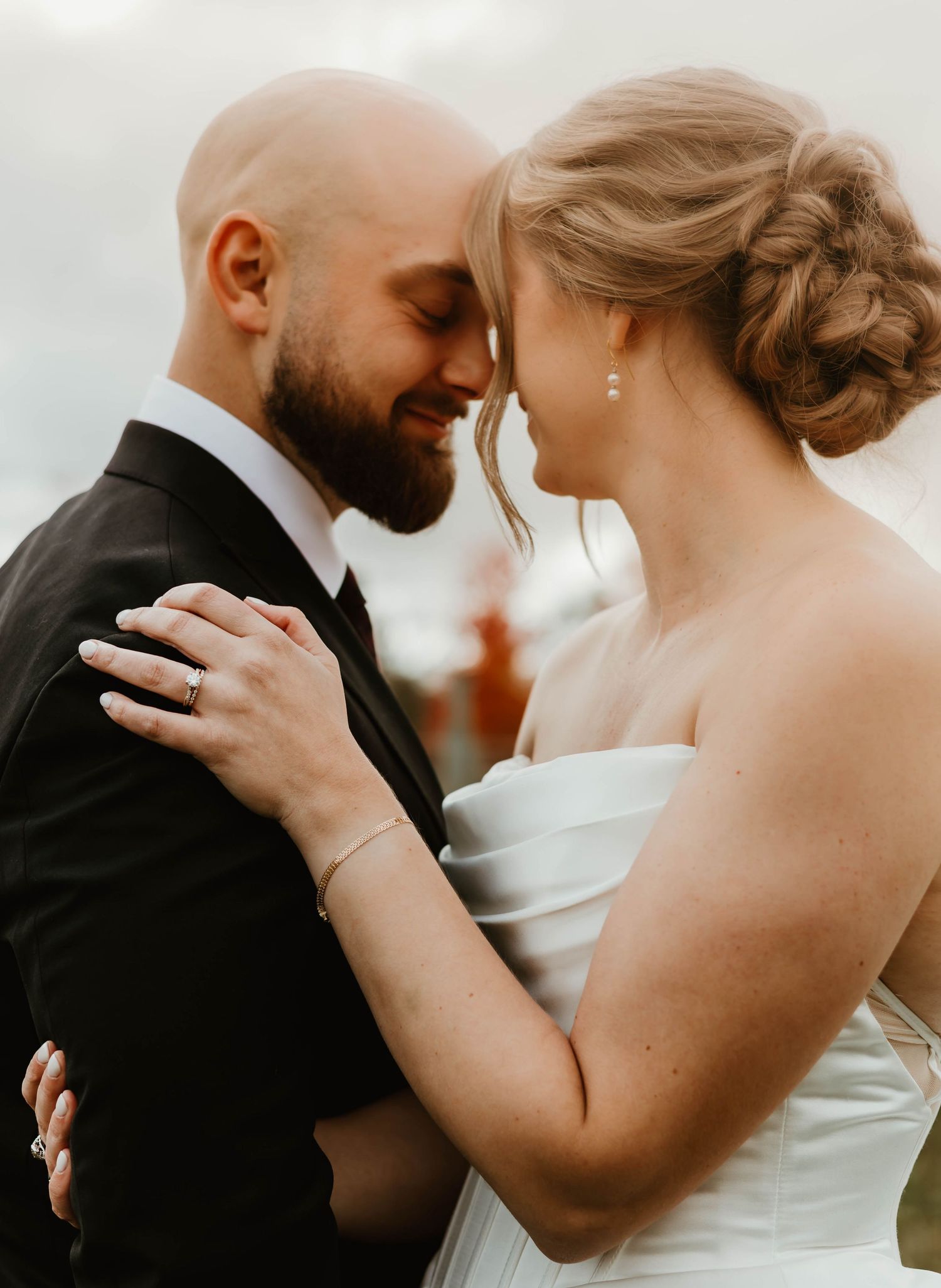 Intimate wedding couple moment captured in soft warm lighting.