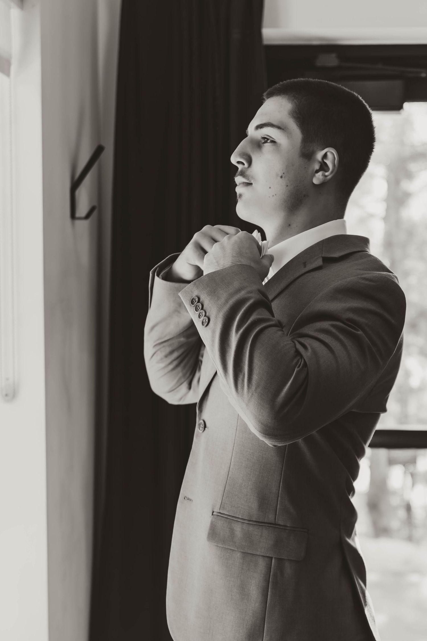 Black and white photo series showing emotional reactions during a first look moment at a wedding.