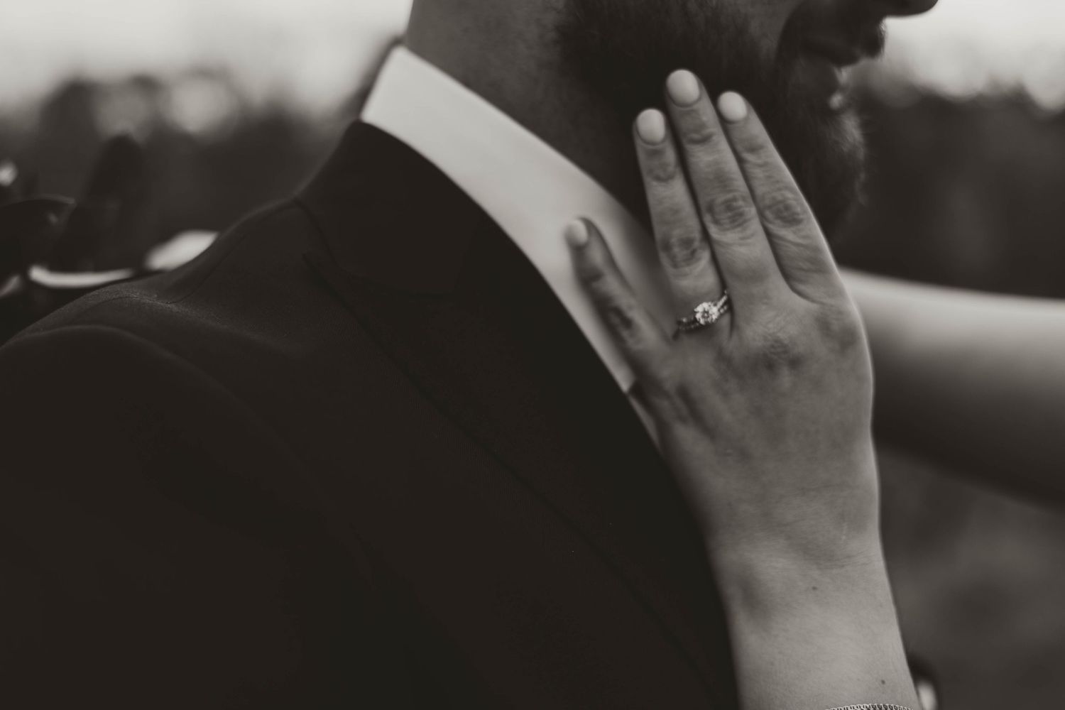 Close-up shot of hands with engagement rings.