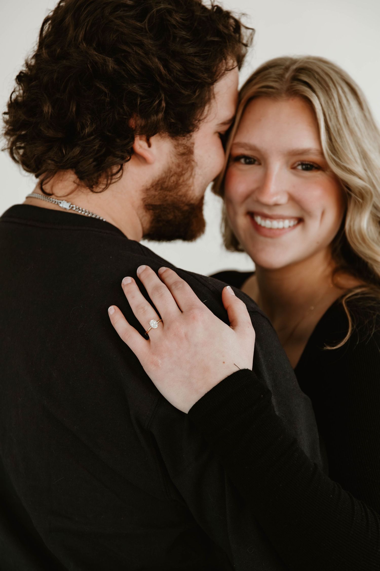 A romantic sequence of engagement photos showing a couple embracing and sharing intimate moments together.