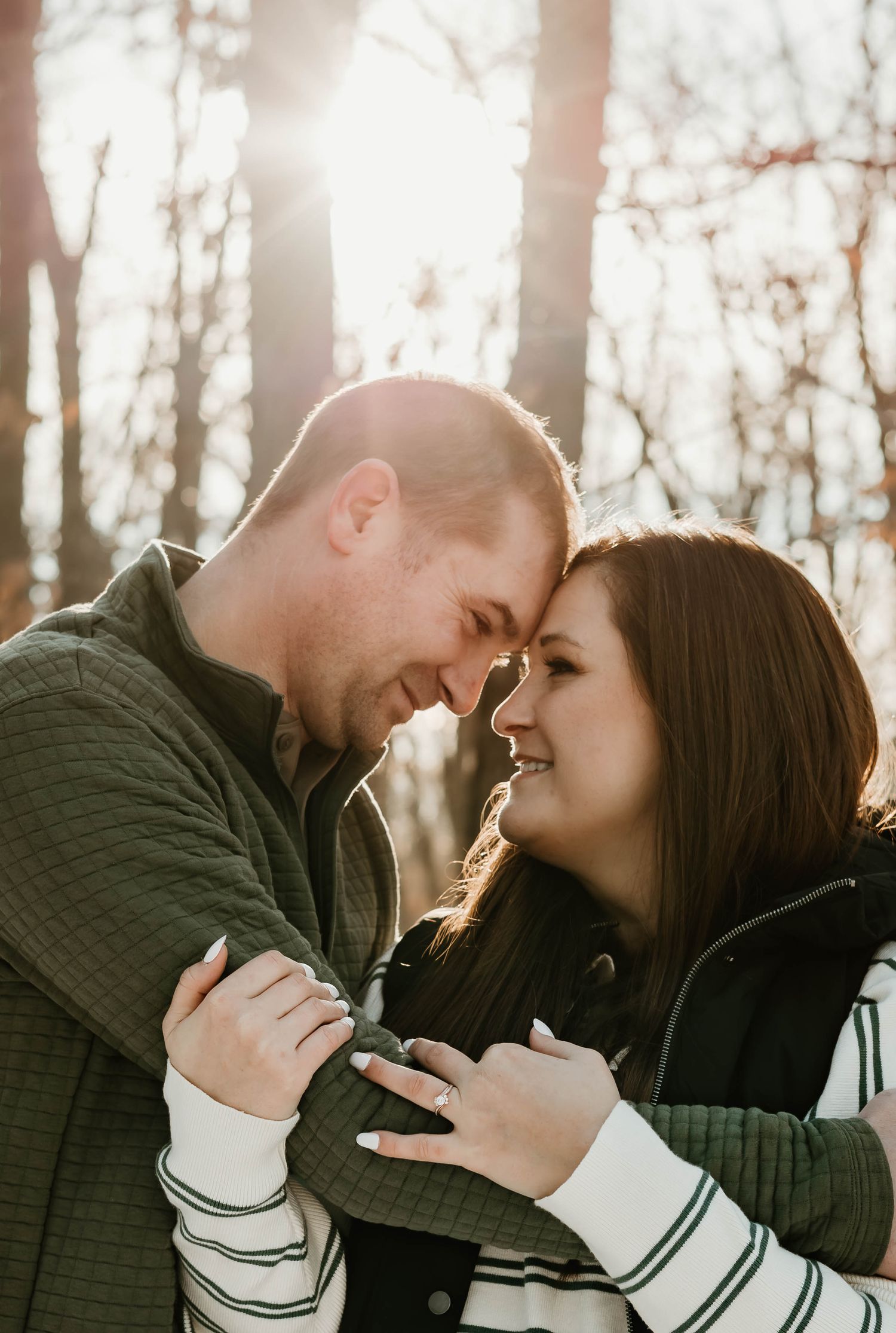 A romantic winter engagement photoshoot sequence showing a couple laughing and embracing in sunlit woods.