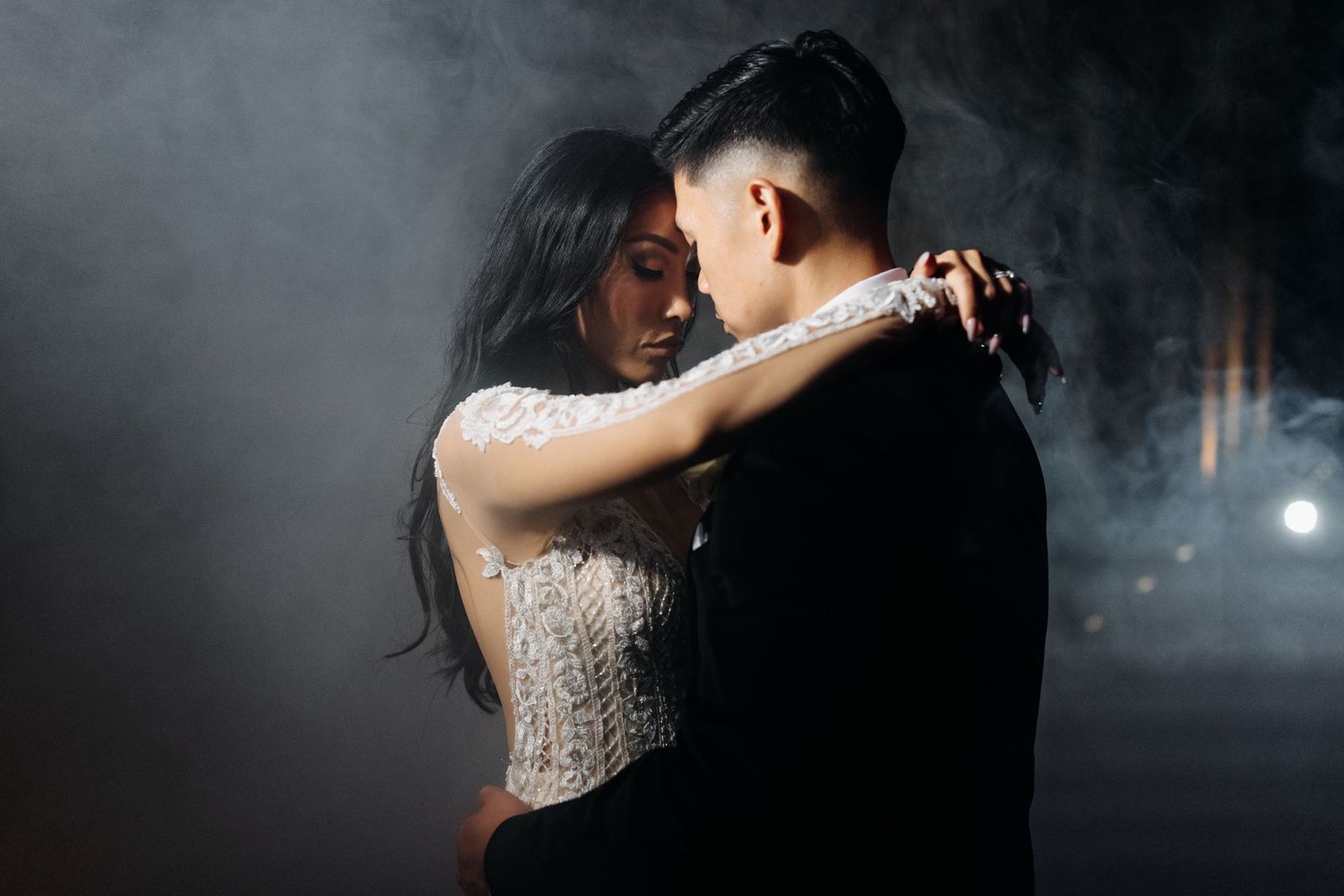 Romantic dance pose with dramatic smoke and lighting effects.