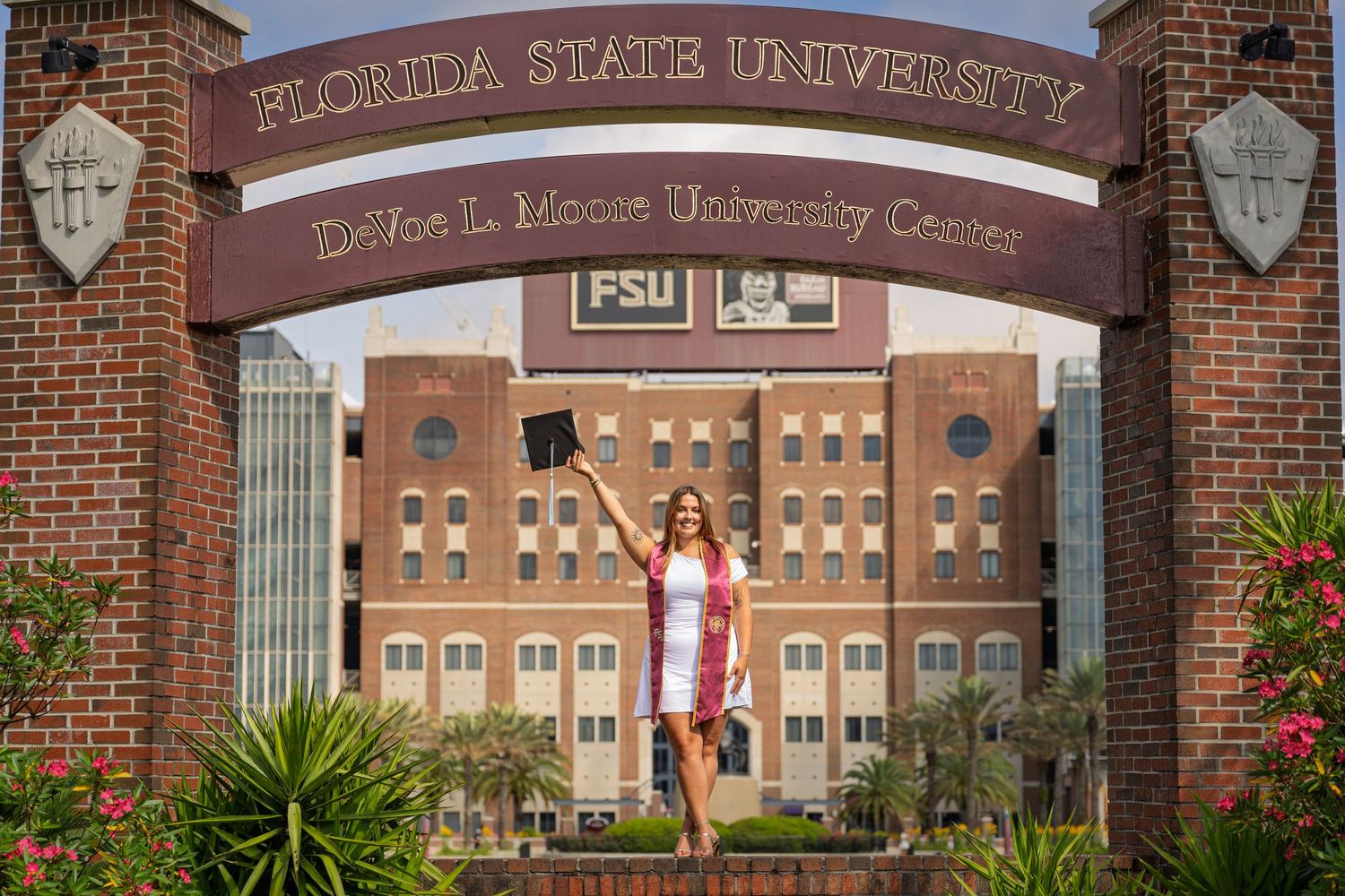 Entrance archway of Florida State University campus with brick buildings and signage.