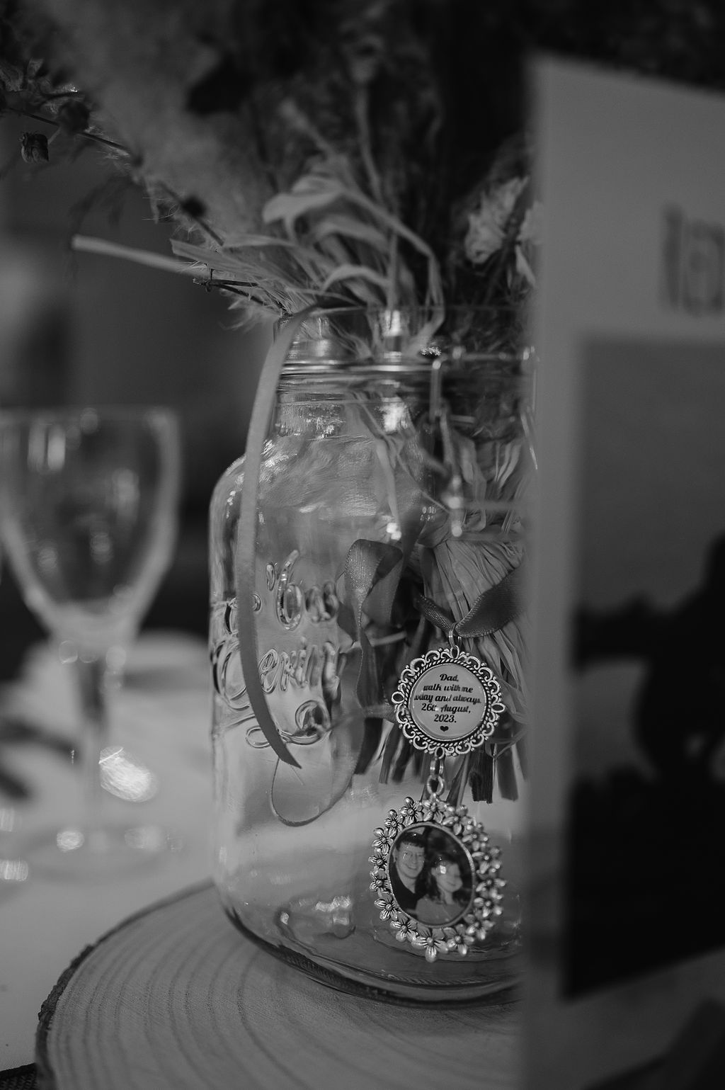 Black and white photo of a decorative mason jar with vintage embellishments.