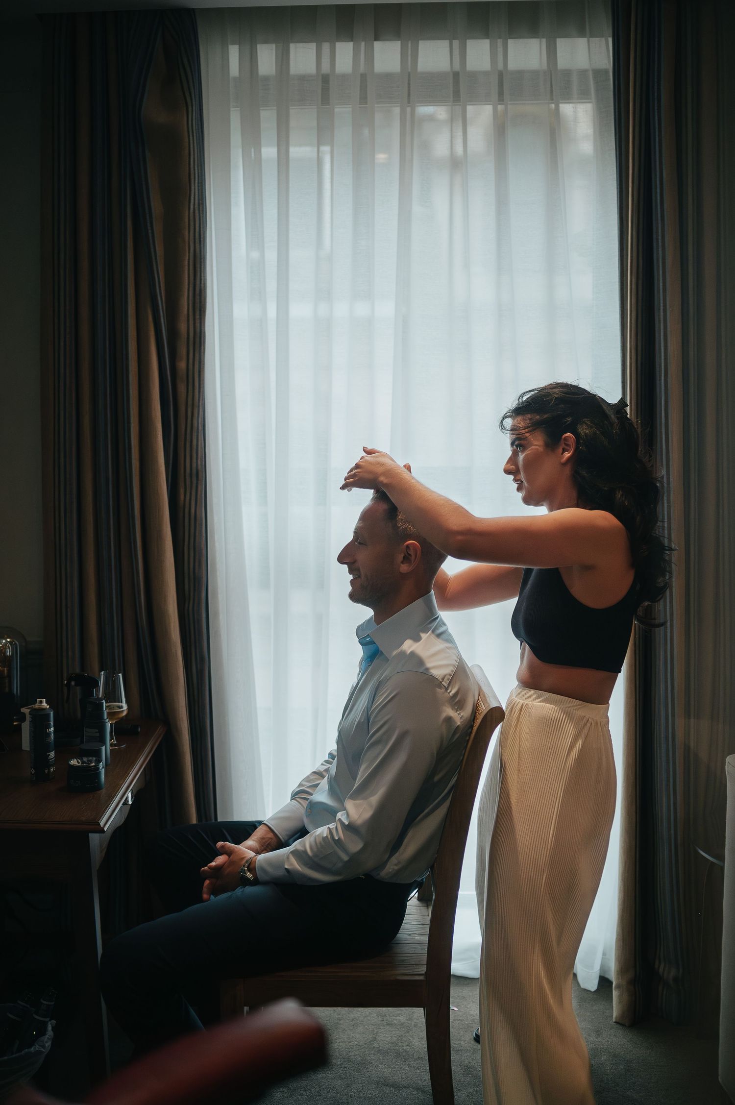 Behind the scenes wedding preparation showing final touches being made indoors.