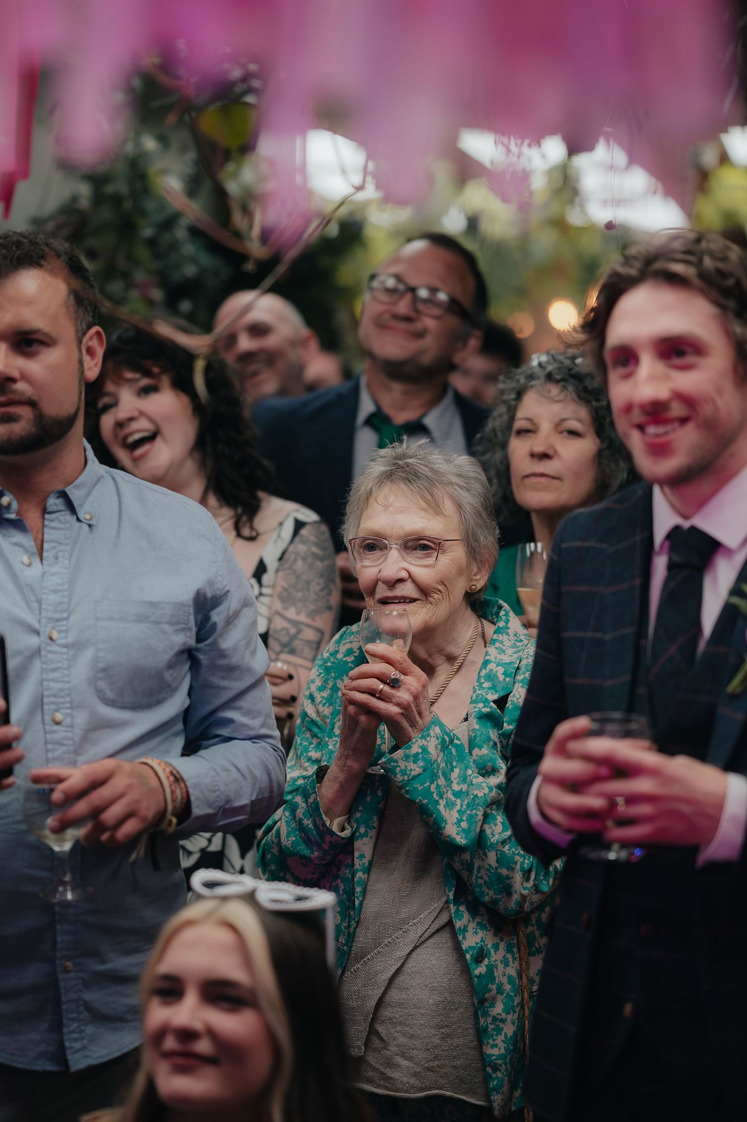 Wedding reception guests enjoying drinks and celebrations at a lively party.