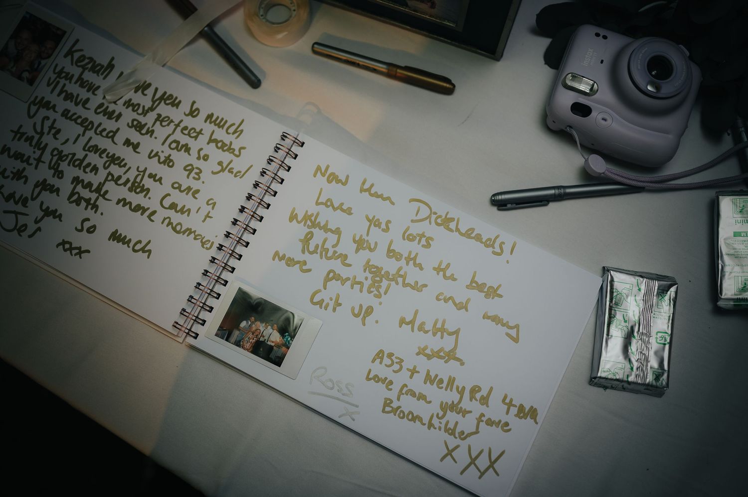 Handwritten wedding vows or notes in a journal with a camera visible.