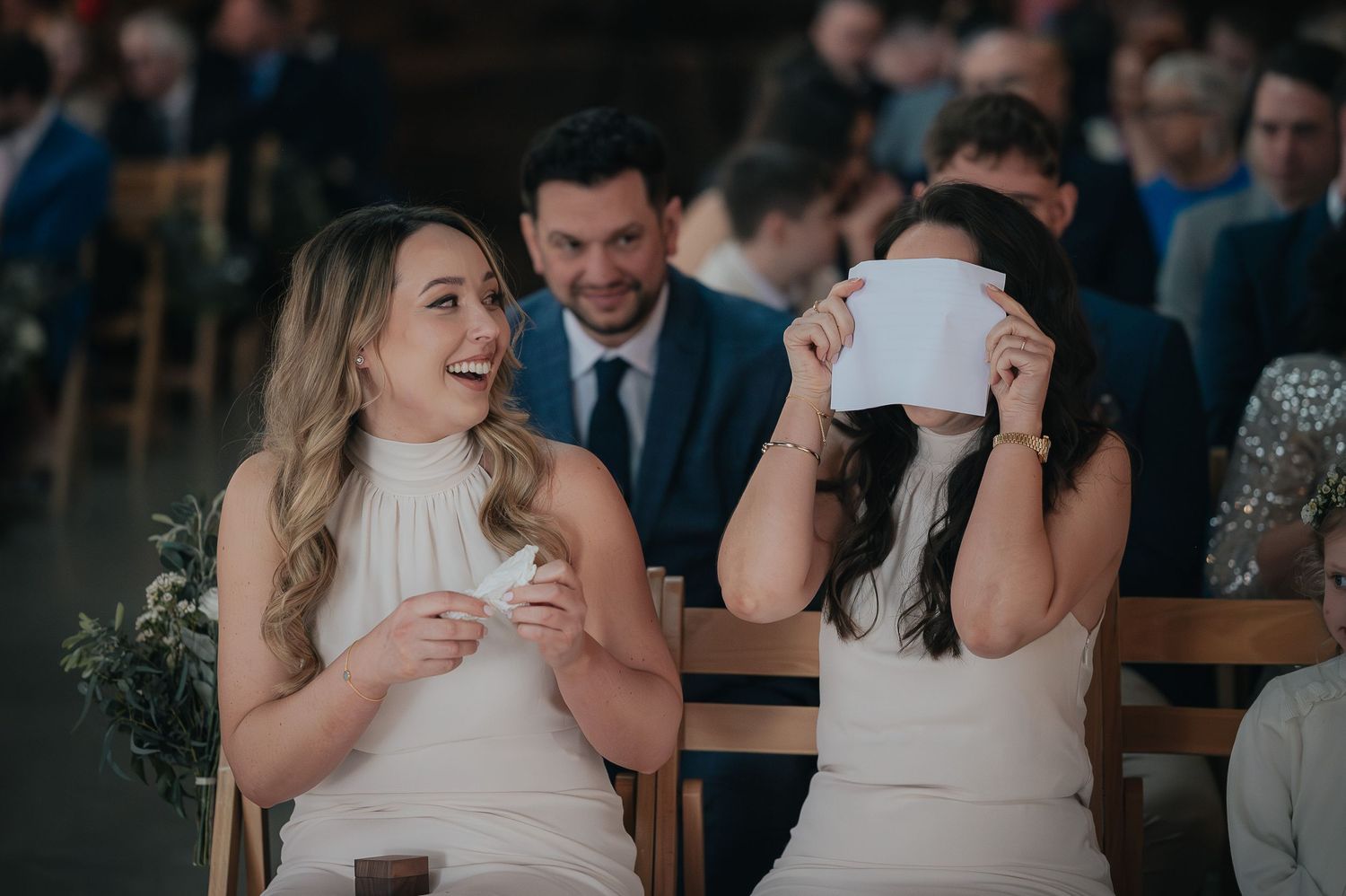Wedding guests react with joy and laughter during emotional ceremony moment.