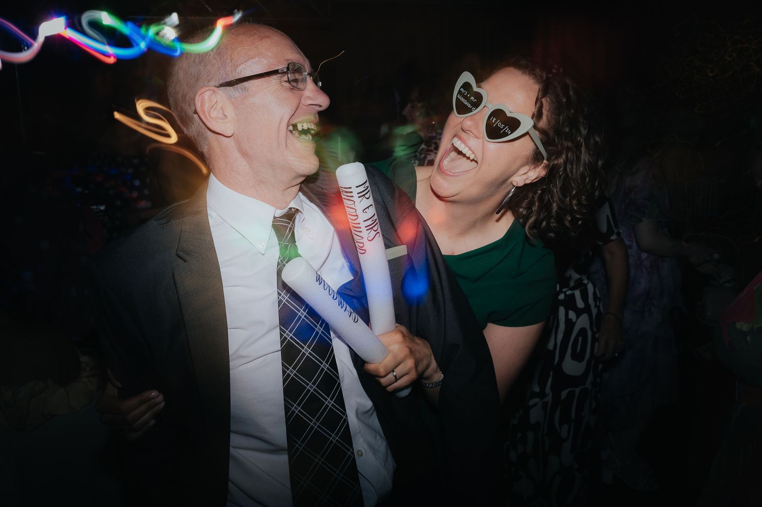 Party celebration with colorful light trails and festive atmosphere.