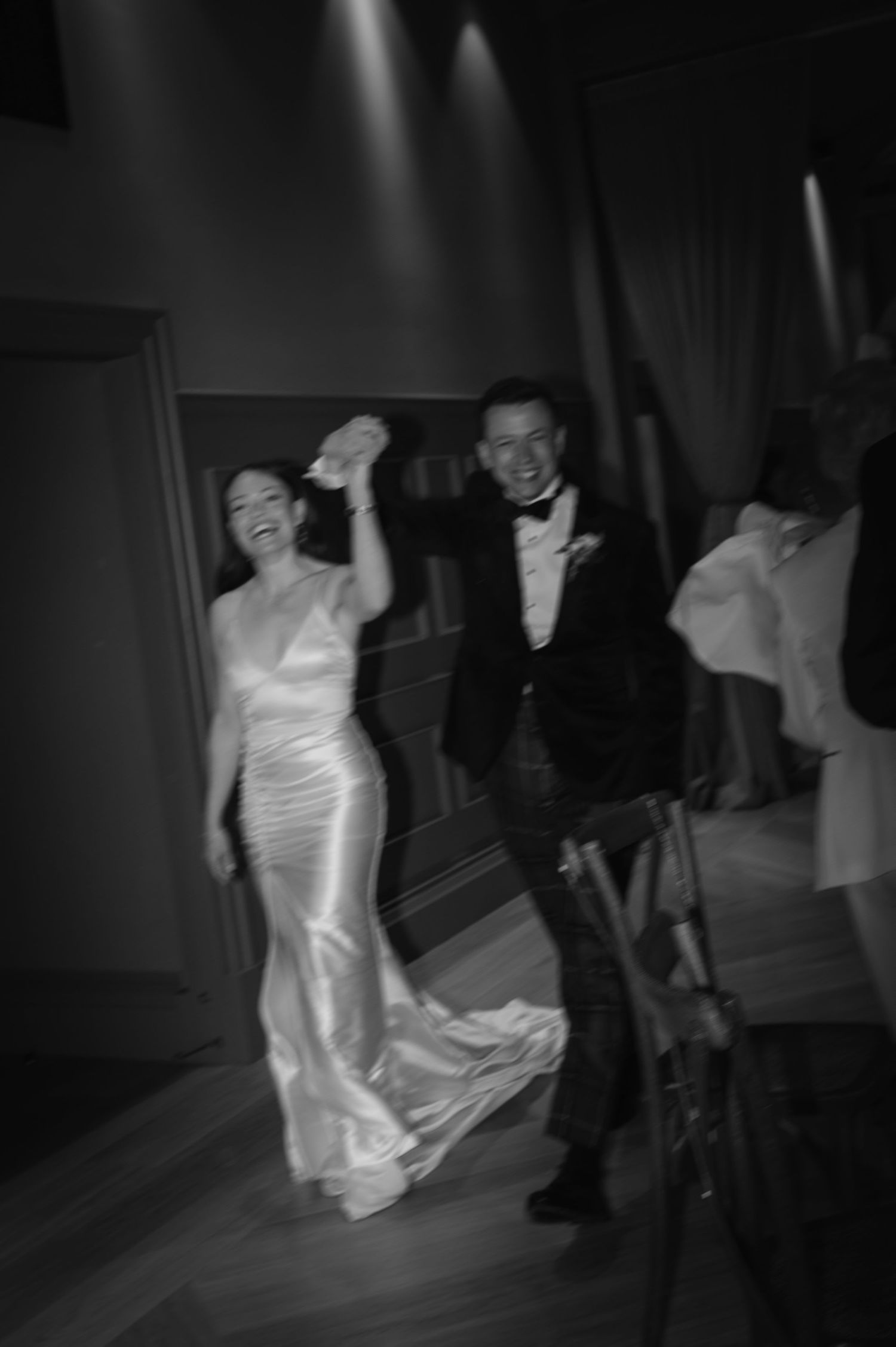 Black and white photos capture dynamic dance movements in a dimly lit room.