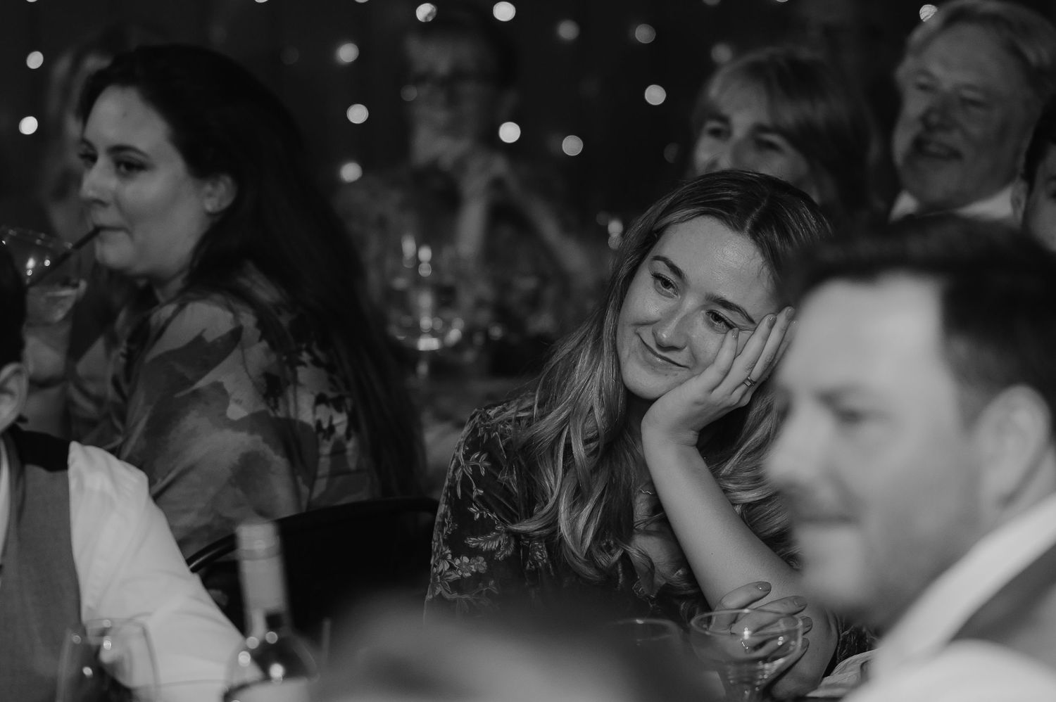 Wedding guests enjoying candid moments during reception dinner.