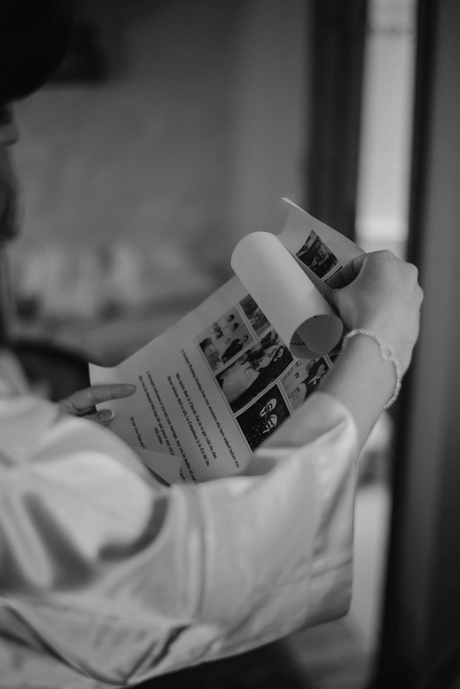 Someone holding and reading a wedding program or order of service.