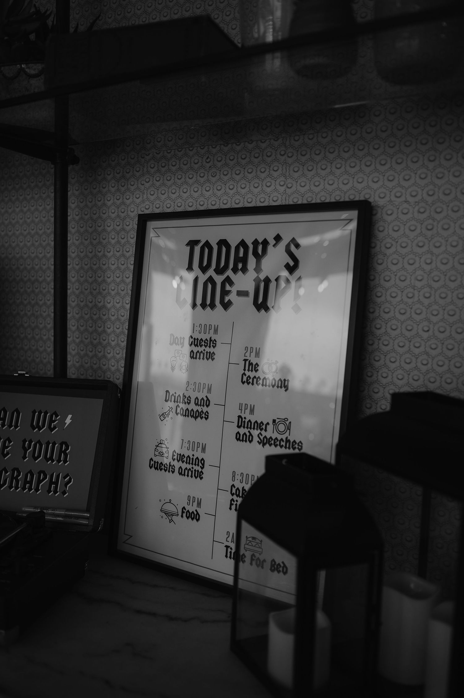 Black and white photograph of a menu board displaying 'Today's Line-up' text in a dimly lit setting.
