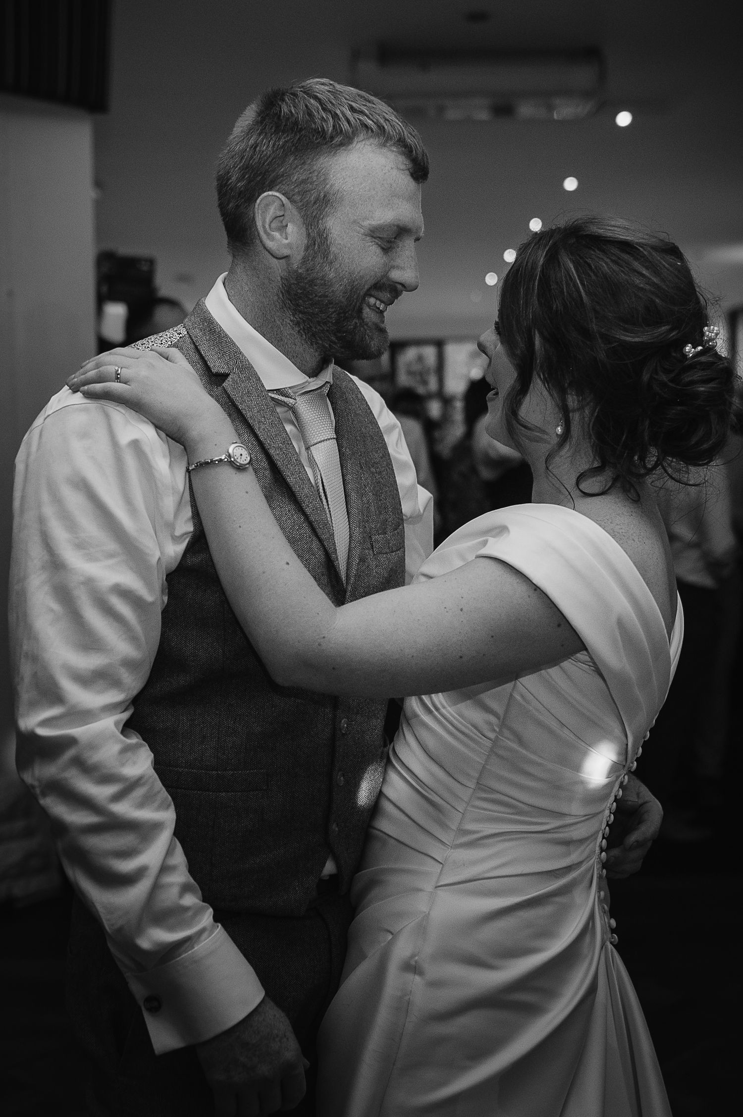 A tender moment captured during a wedding first dance in black and white.