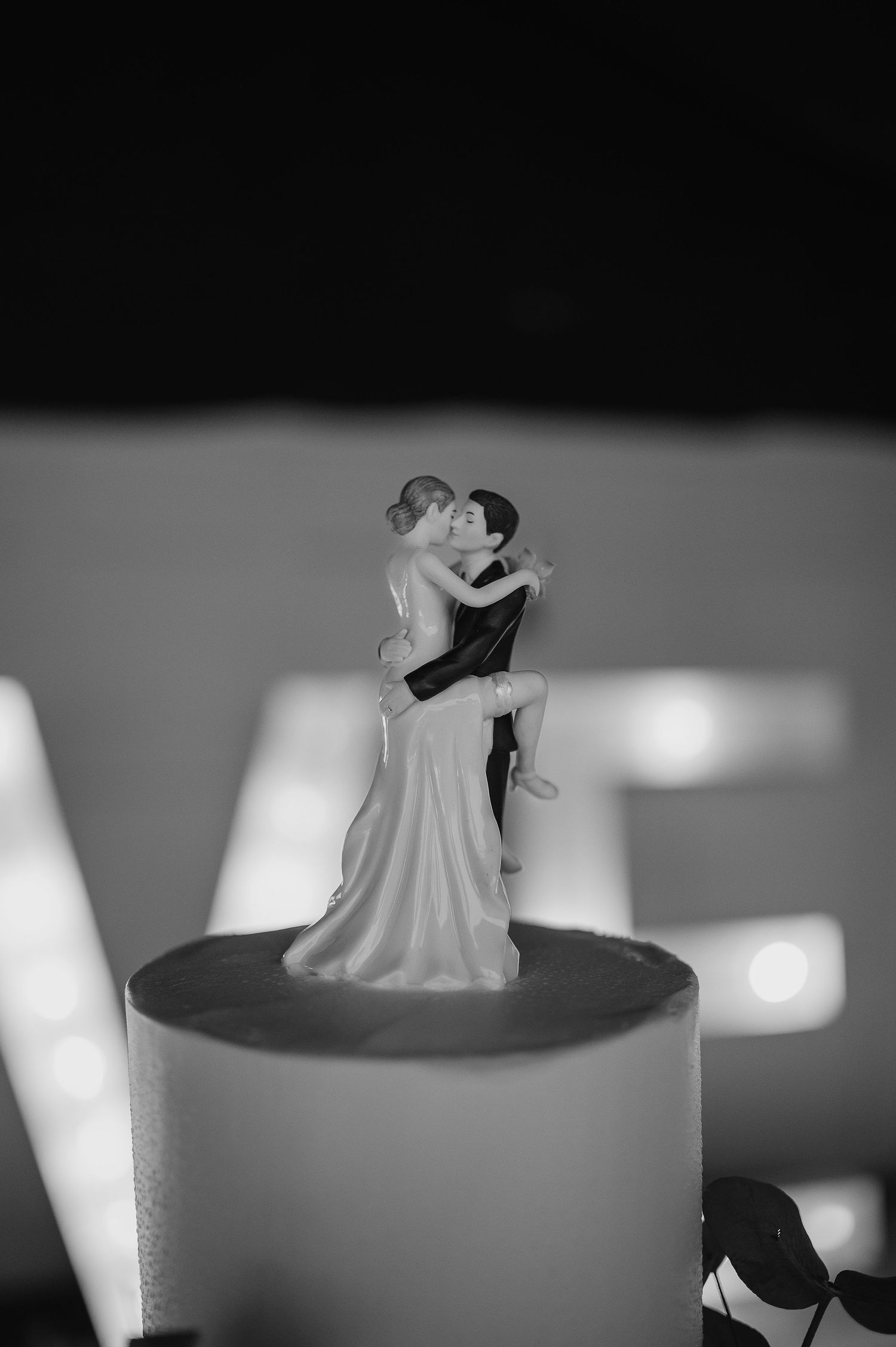 Close-up of wedding cake topper figurine in black and white.