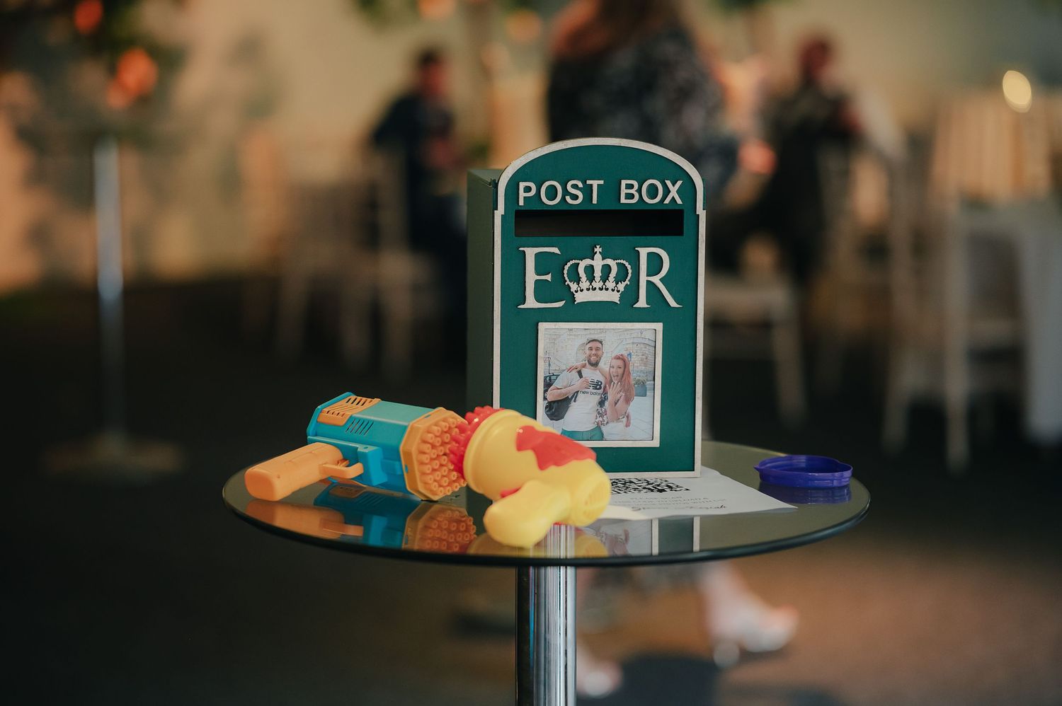 Post box and colorful candies displayed on a table at a wedding reception.