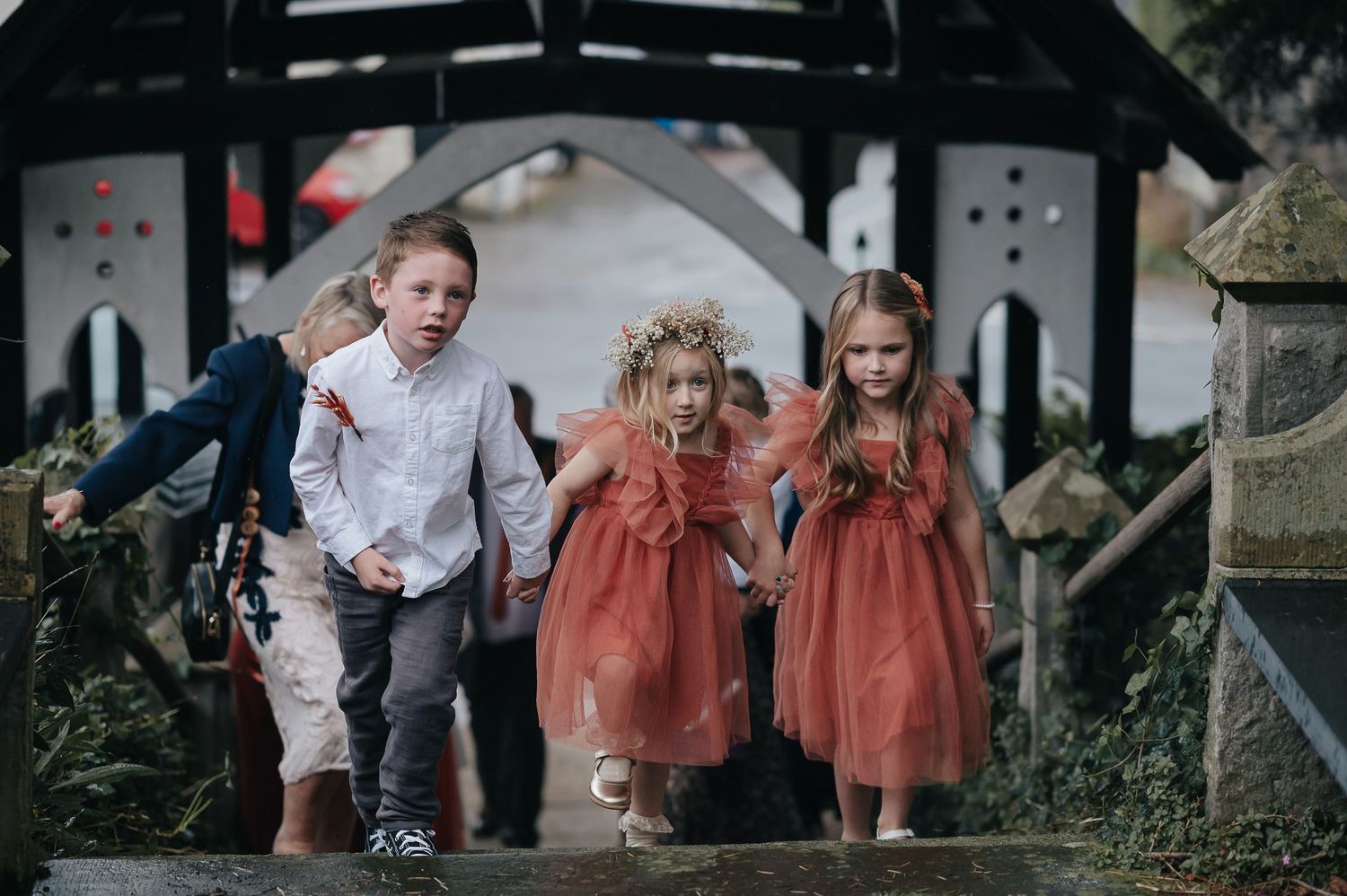 Children in formal attire running through a church archway.