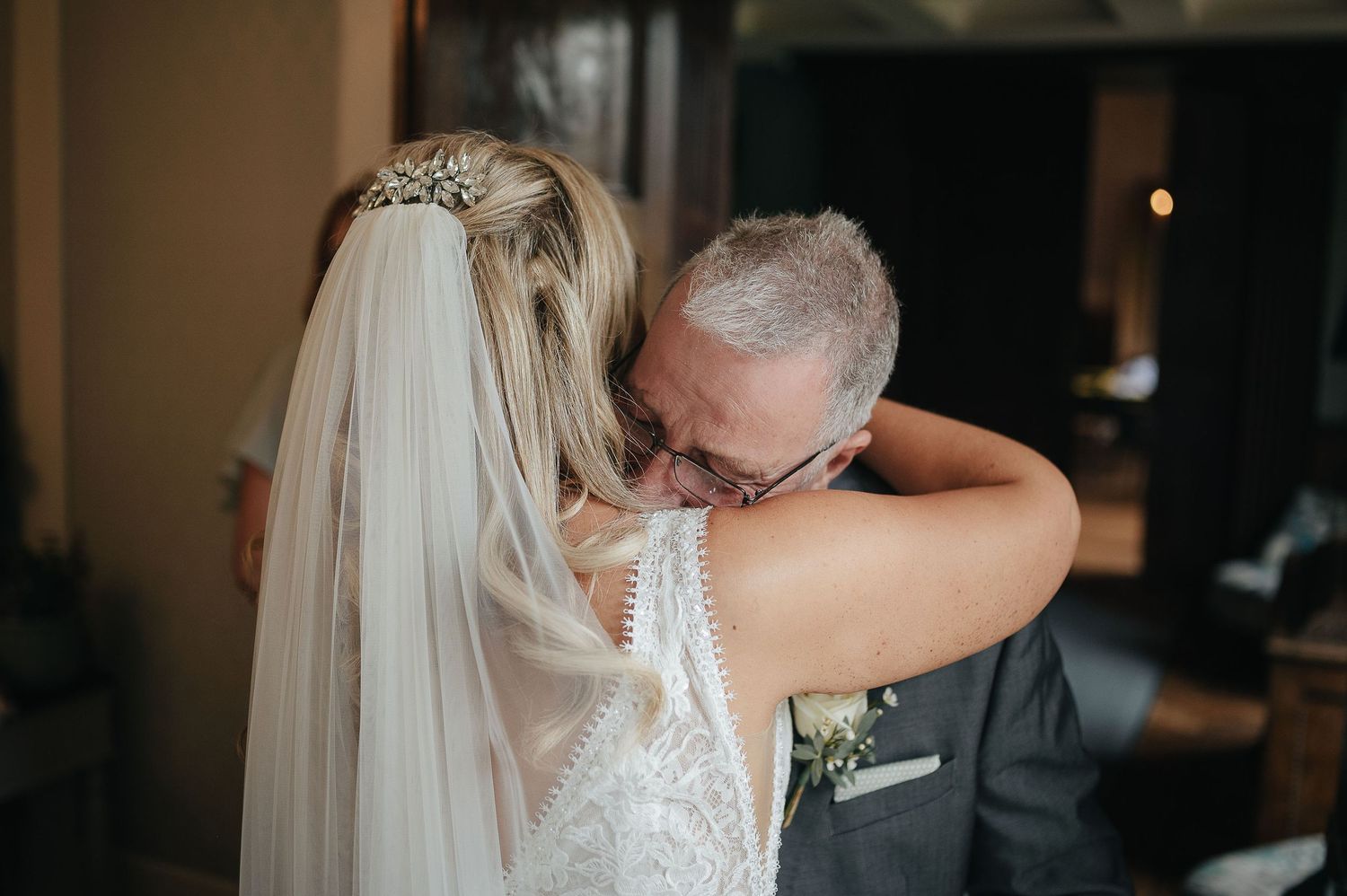An emotional wedding moment captured during an intimate embrace between the bride and her loved one.