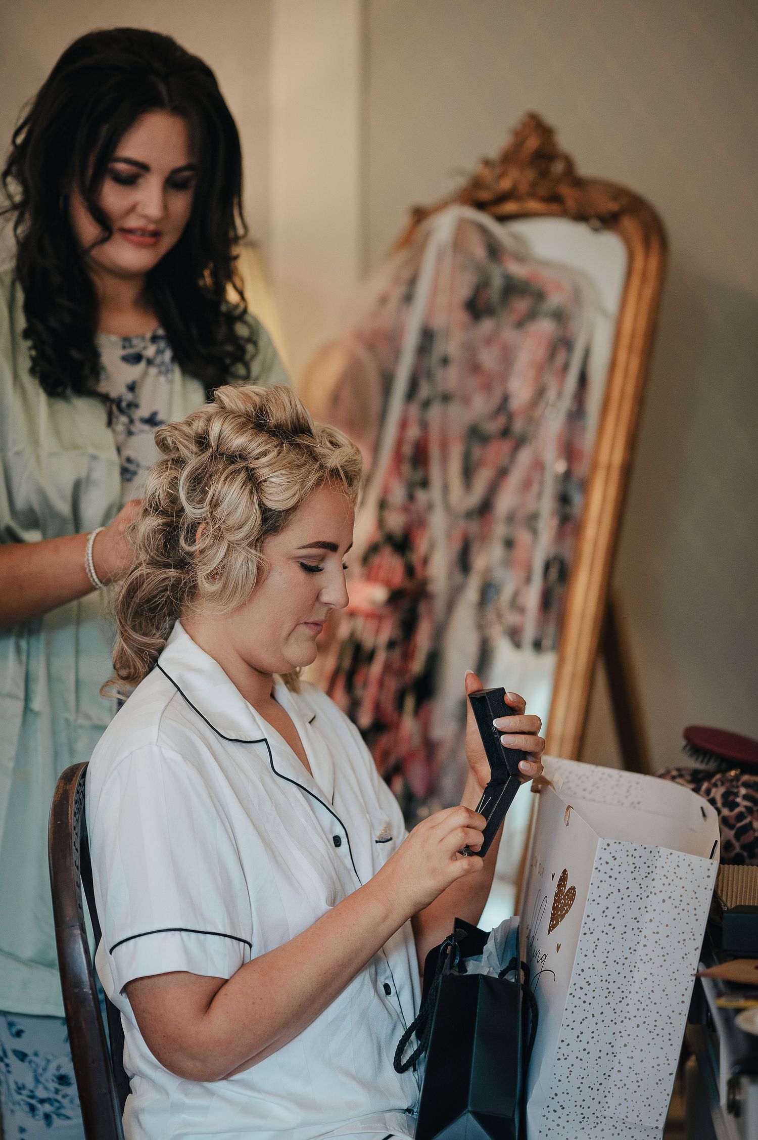 Getting ready scene showing preparations with an ornate vintage mirror in the background.