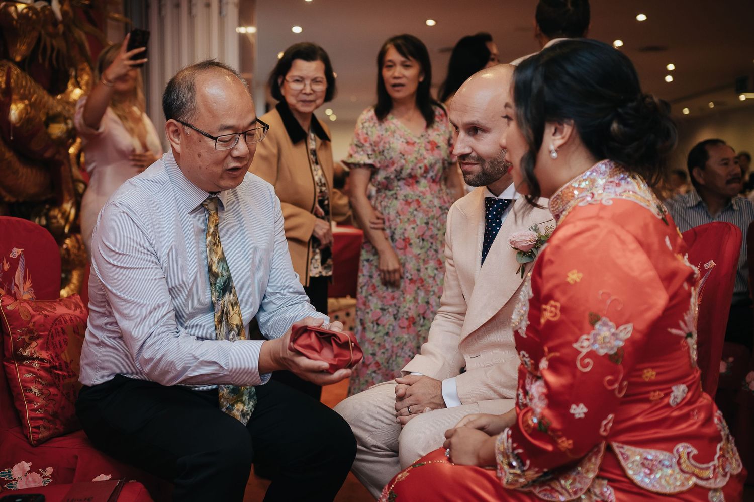 Traditional Chinese tea ceremony scene with cultural wedding attire and customs.