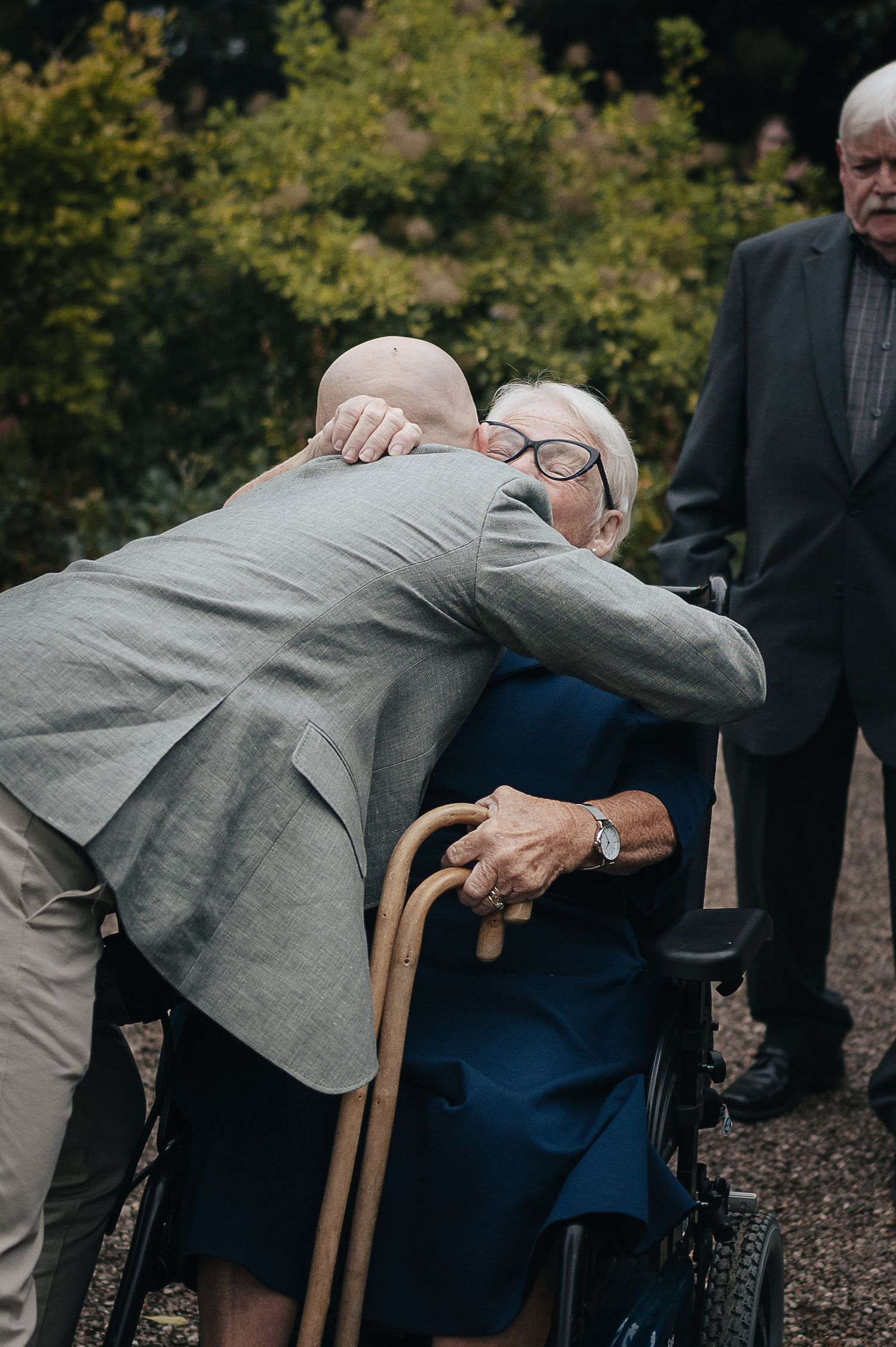 An emotional moment shared between people at an outdoor gathering.