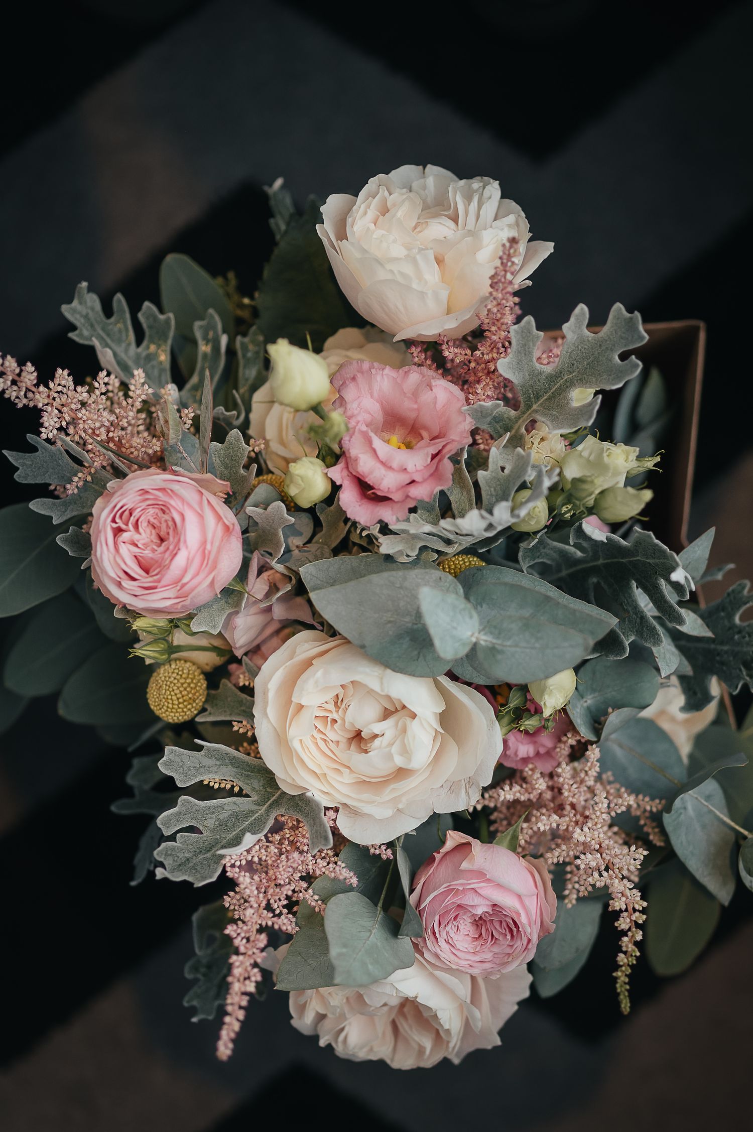 Romantic floral arrangement with pink roses, peonies and eucalyptus leaves.