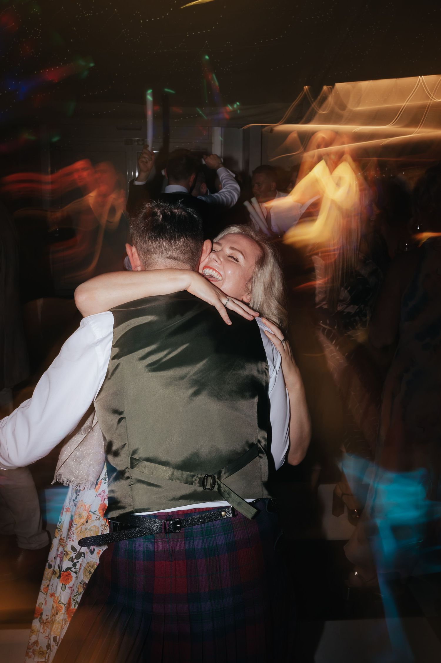 A couple sharing a romantic dance moment at a wedding reception.