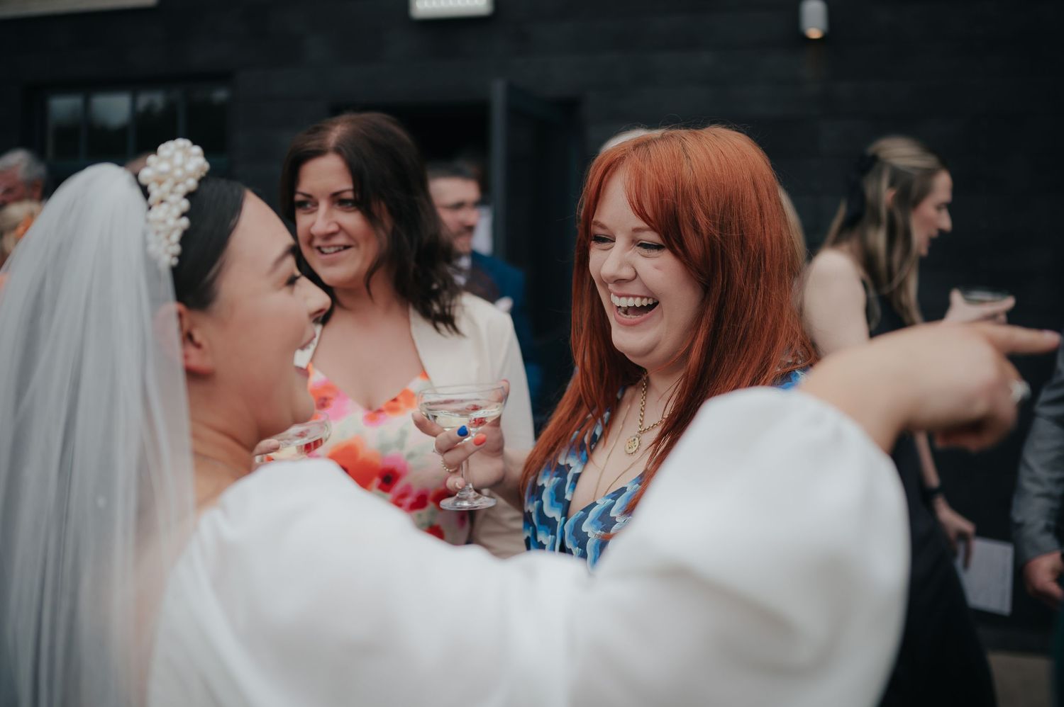 Wedding guests share laughs and embraces during reception celebrations.