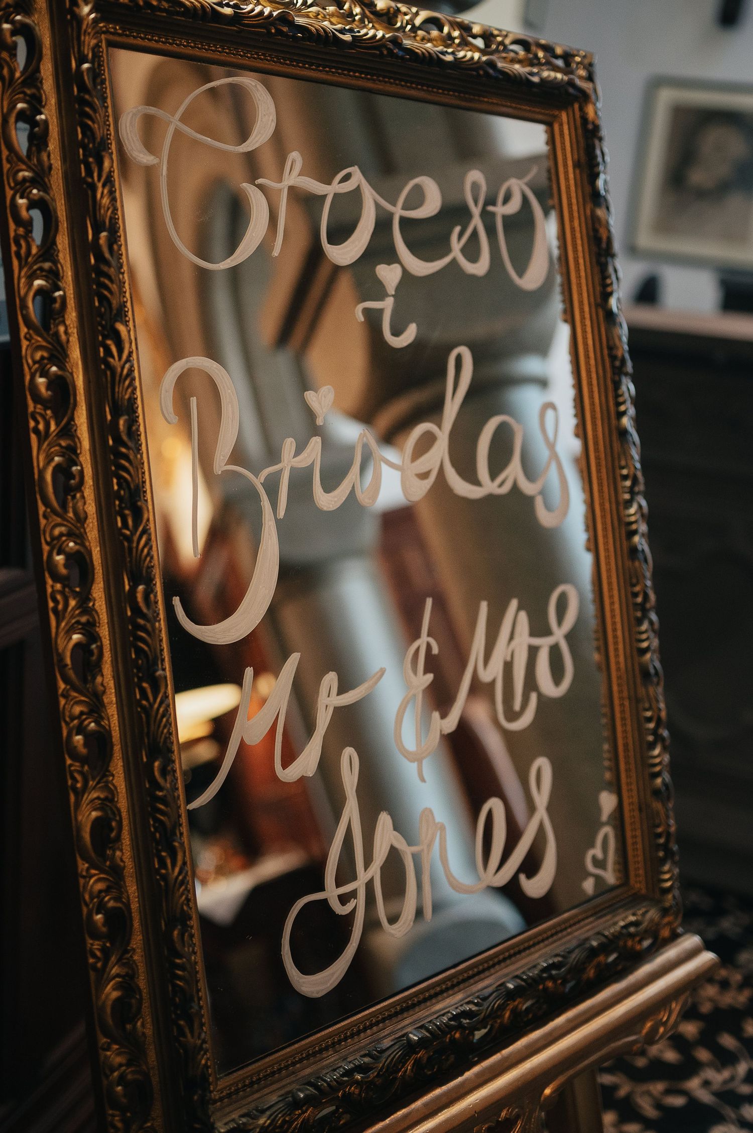 Ornate vintage frame with 'Espresso & Brindare' handwritten text on mirrored surface.