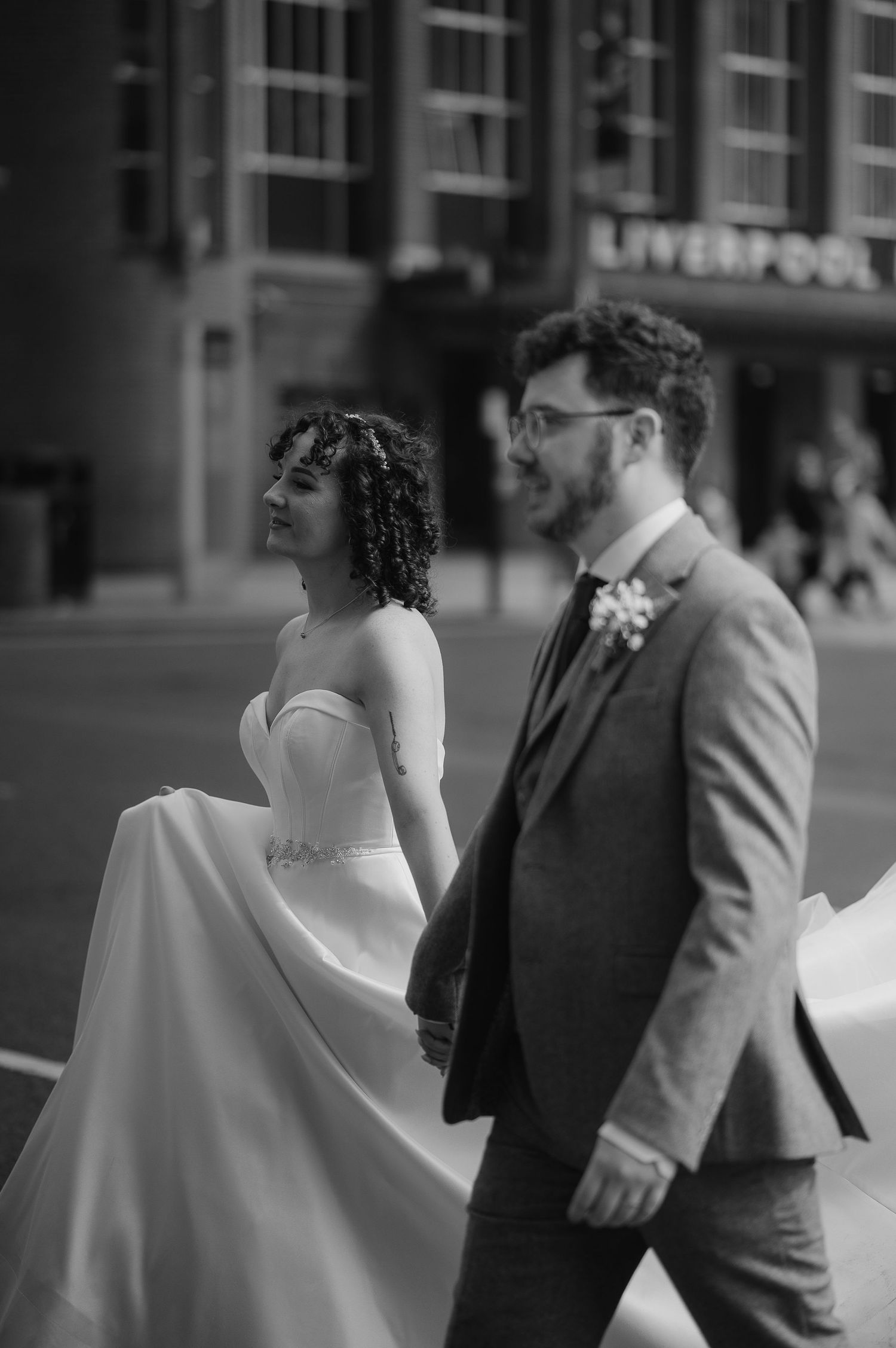 A black and white wedding portrait captured on an urban Liverpool street.