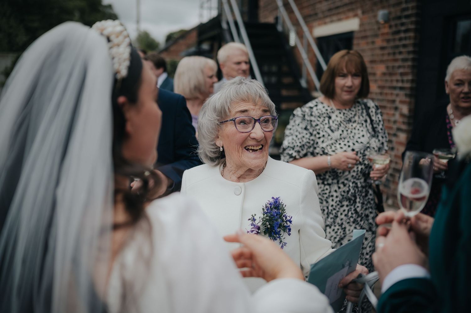 Wedding guests share joyful moments during outdoor reception celebrations.