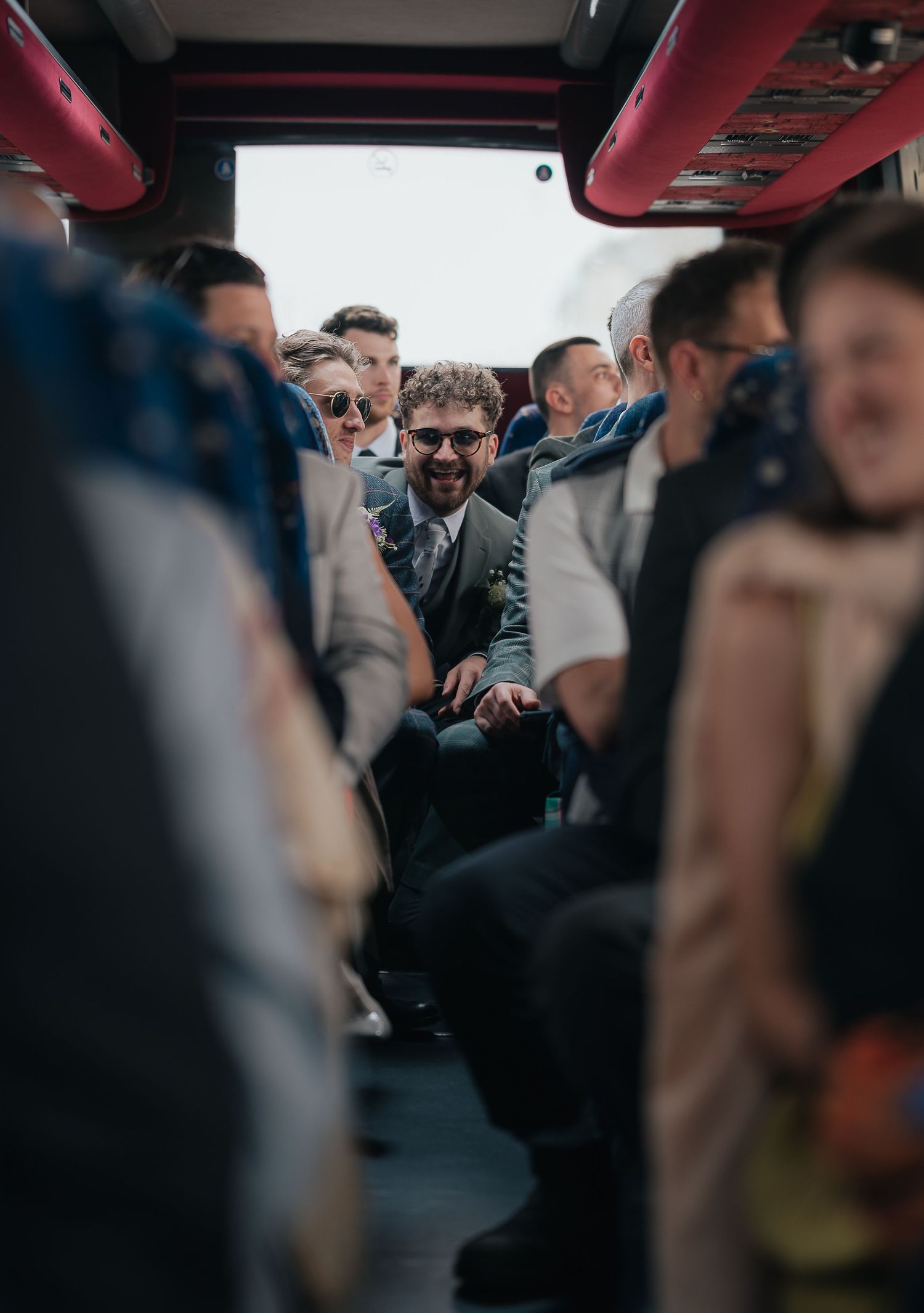 Interior view of passengers seated inside a crowded tour bus.