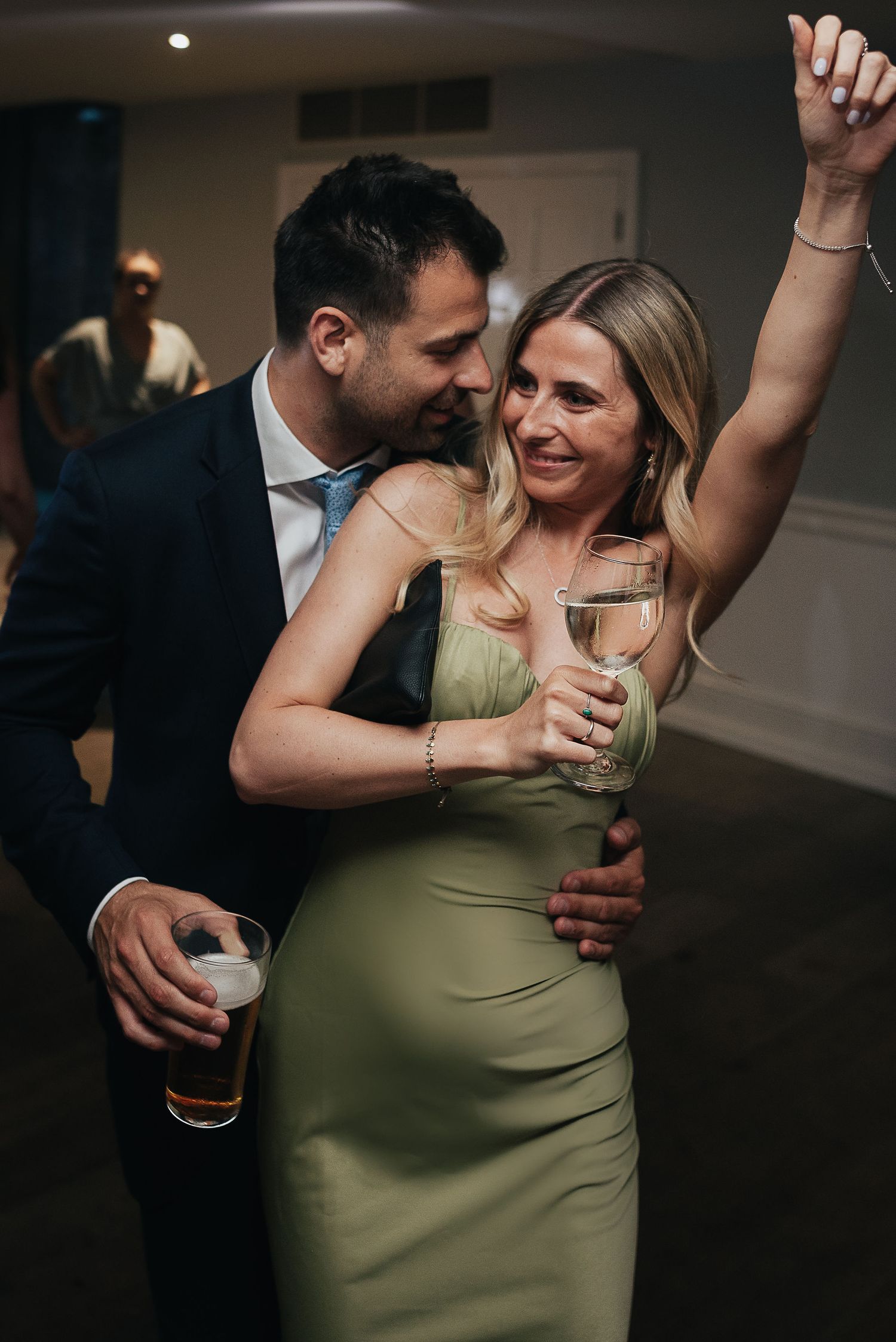 Couple sharing an intimate moment while dancing together at an evening party.